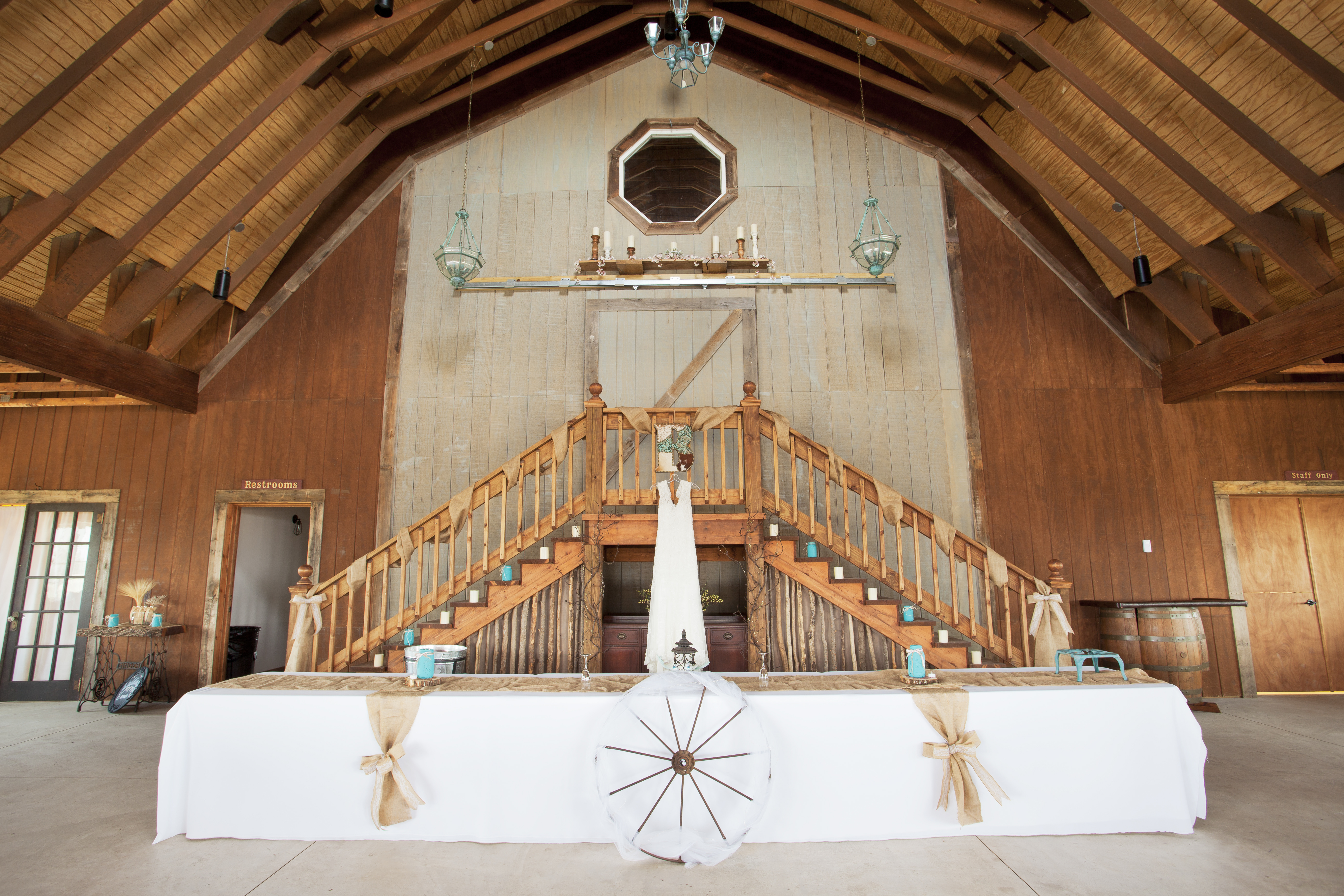 Rustic barn wedding venue with wedding dress in the middle