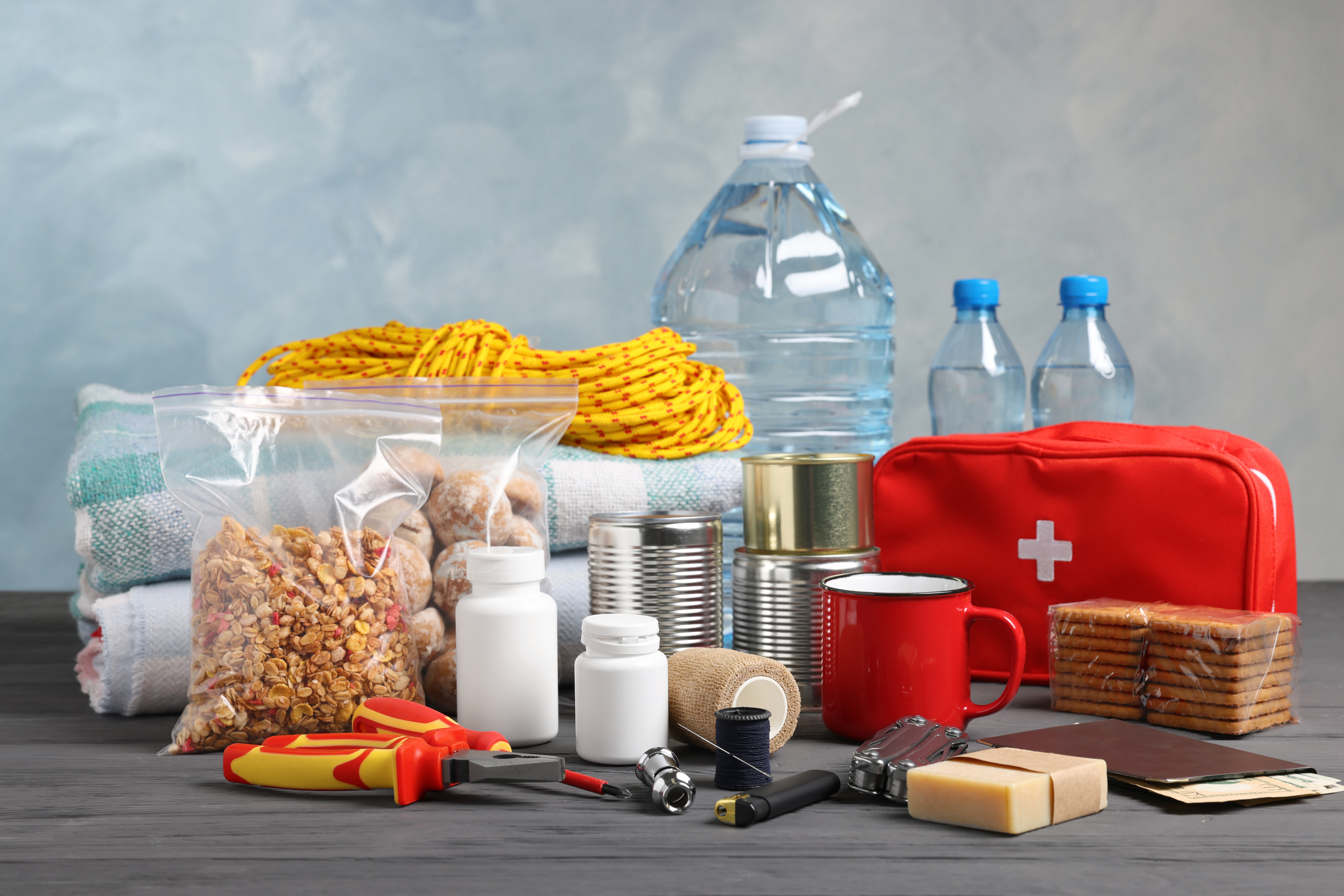 Disaster supply kit for earthquake on black wooden table