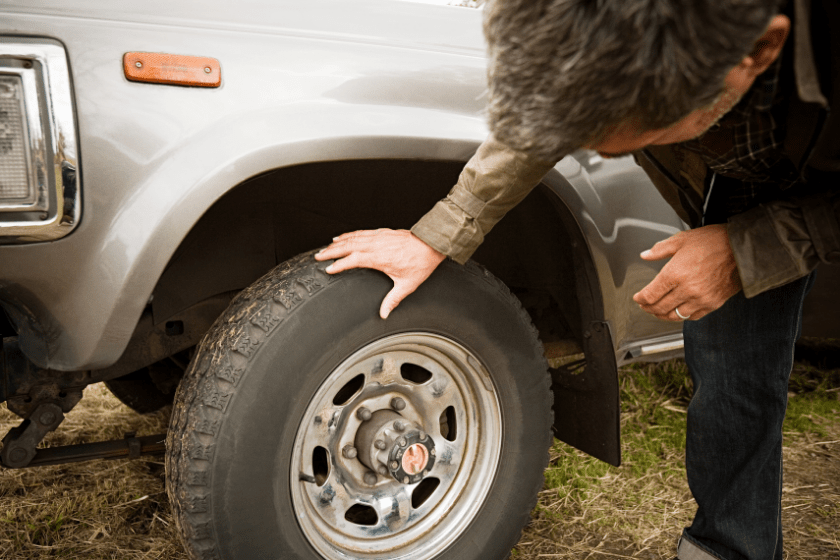 Man checking car tire