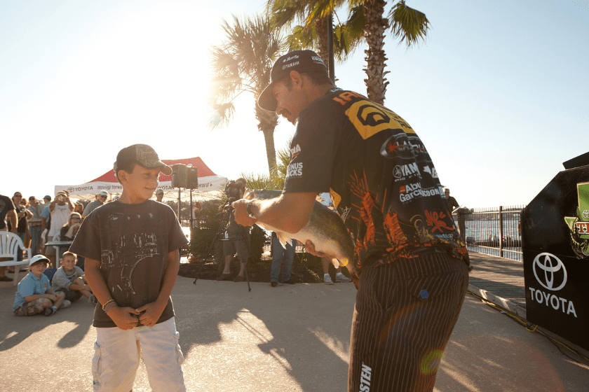 Angler Mike Iaconelli shows off his catch to the fans during the Toyota Texas Bass Classic at Lake Conroe in Conroe, Texas on October 1, 2010.