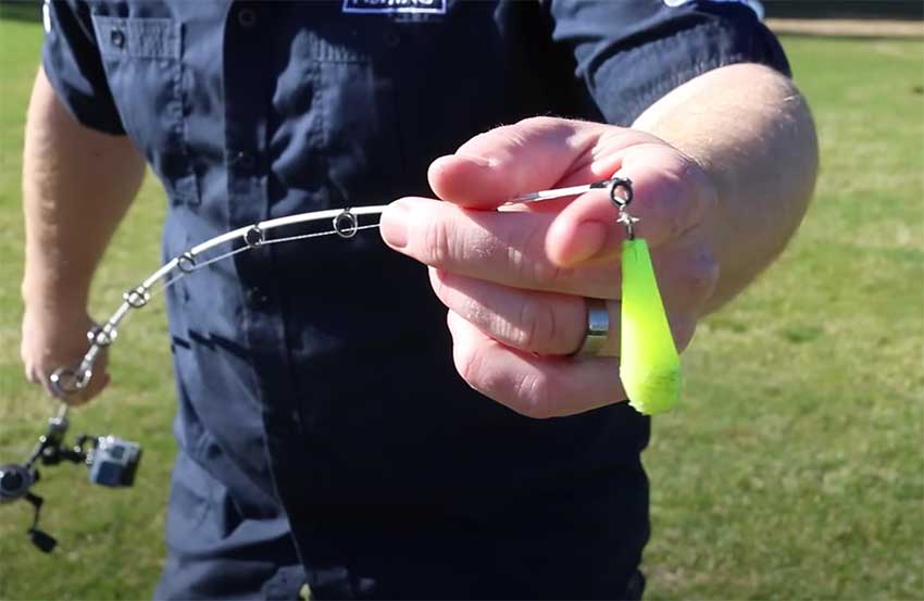 Angler holds a fishing rod with a casting plug attached