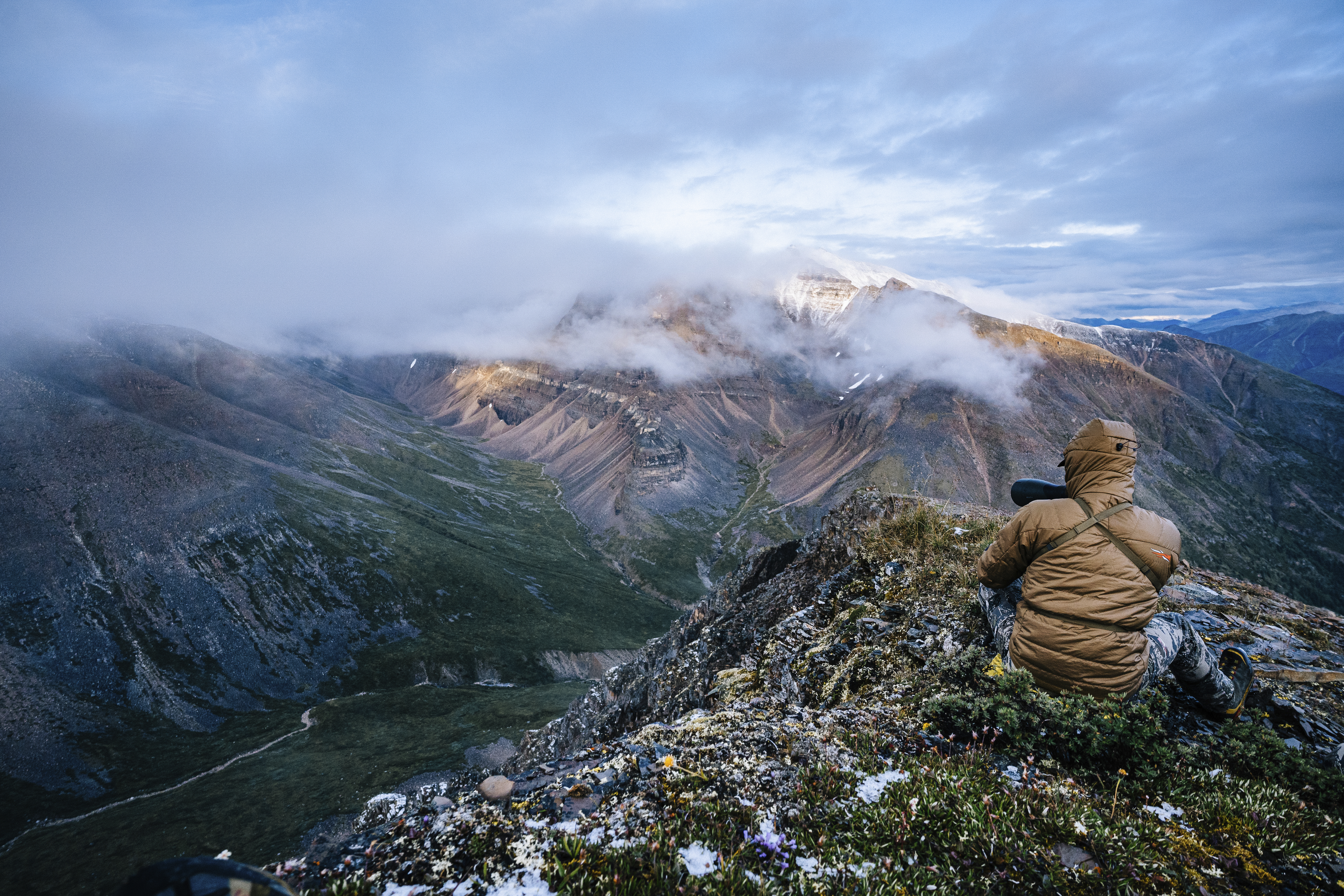 a hunter scouting for elk or deer on a mountaintop