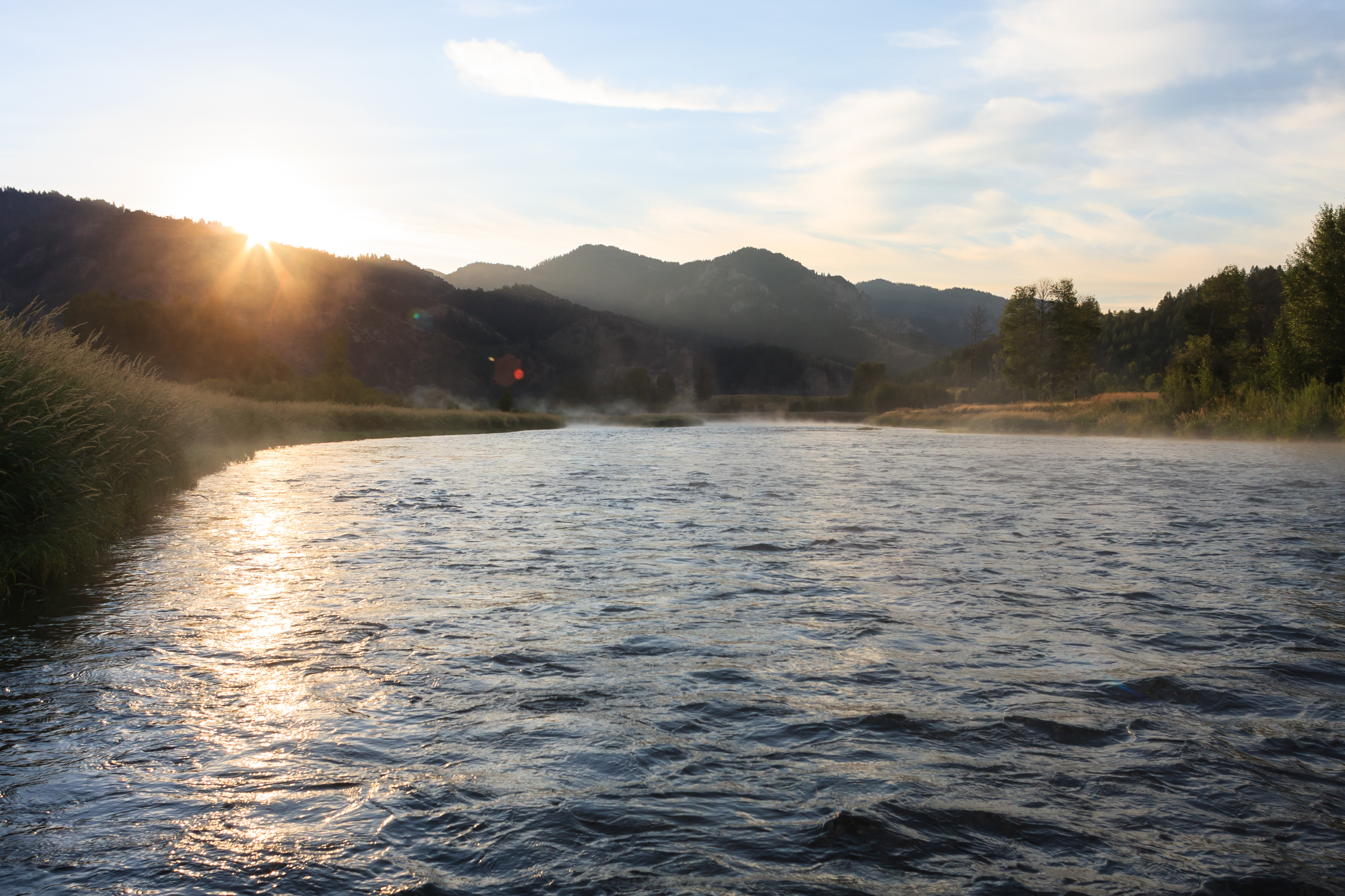 The sun rises above the canyon of the South Fork Of The Snake River.