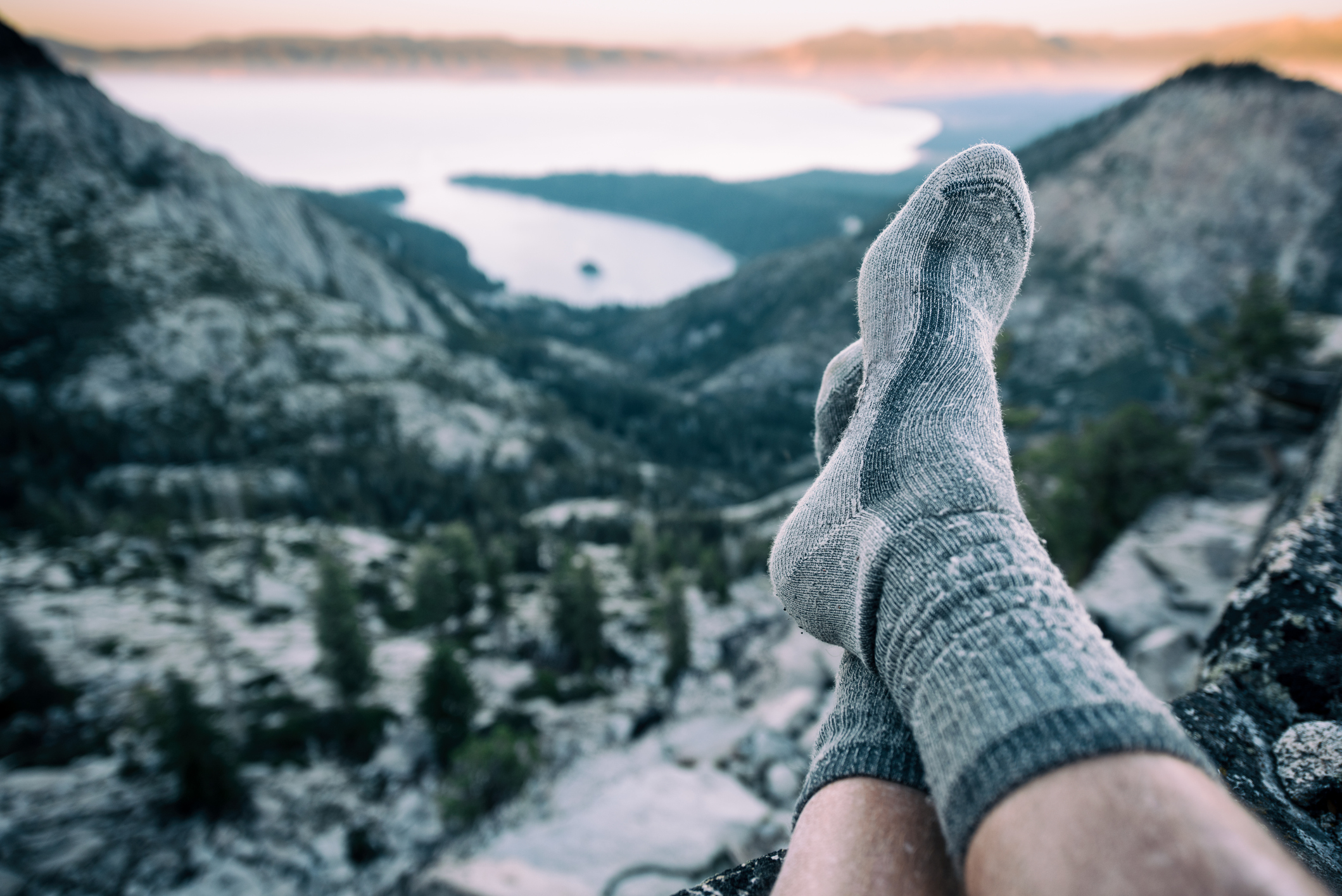 A person takes a rest after a long climb to the summit of a mountain in Lake Tahoe, California