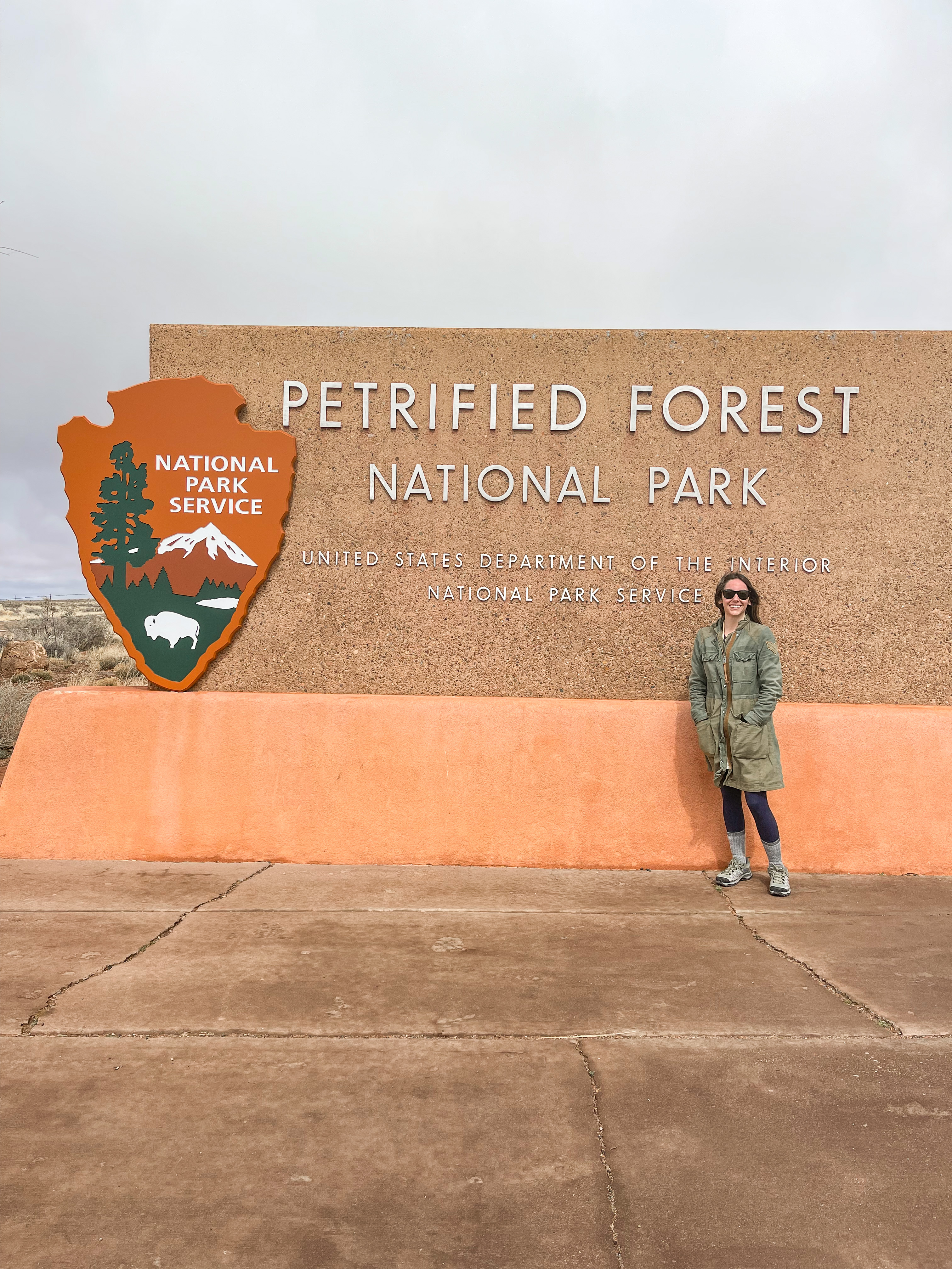 Kendra in front of Petrified Forest sign
