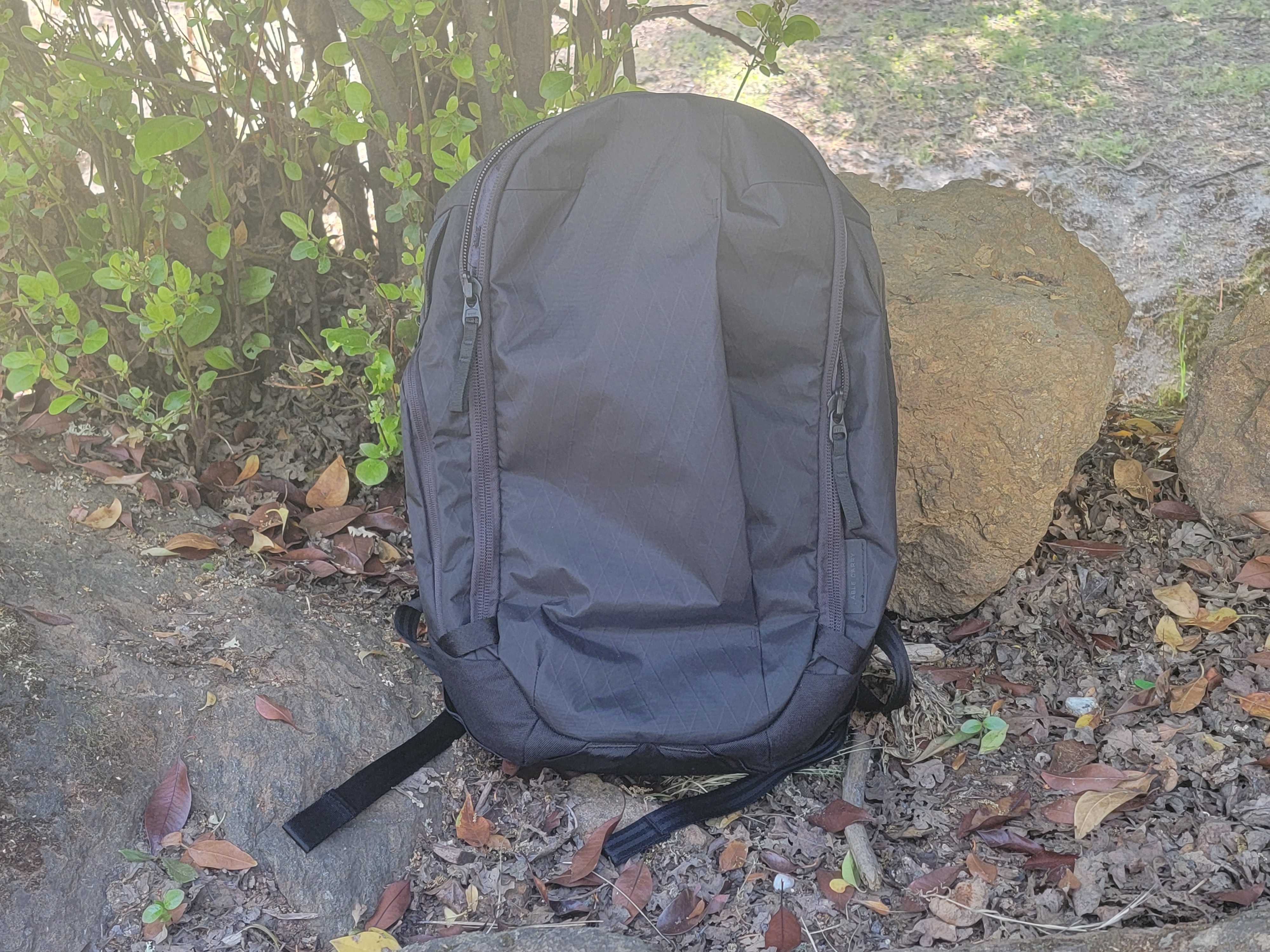 Black Max Backpack sitting up against a rock