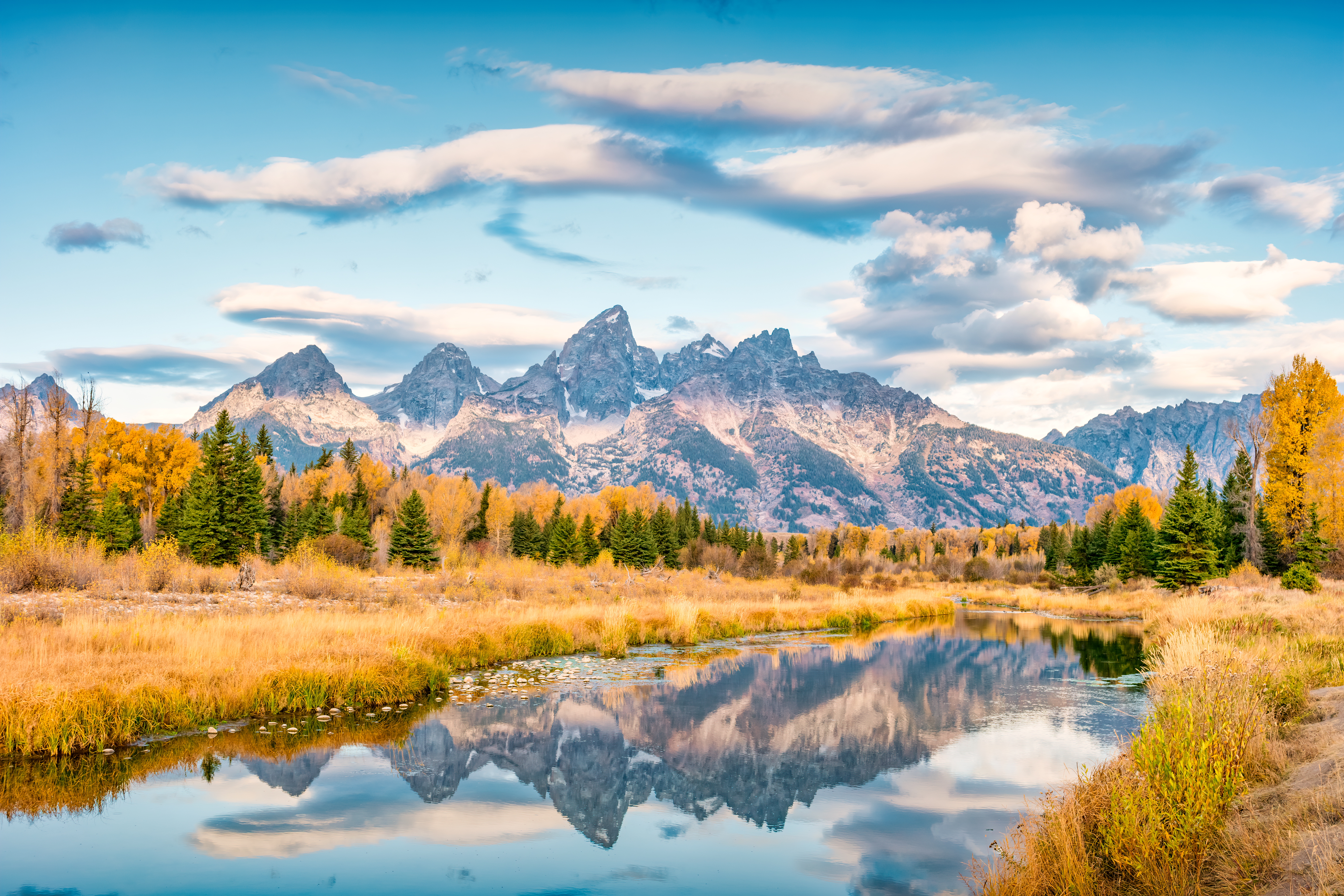 Grand Teton reflection in the Snake River in Grand Teton National Park, Wyoming, USA at sunrise.