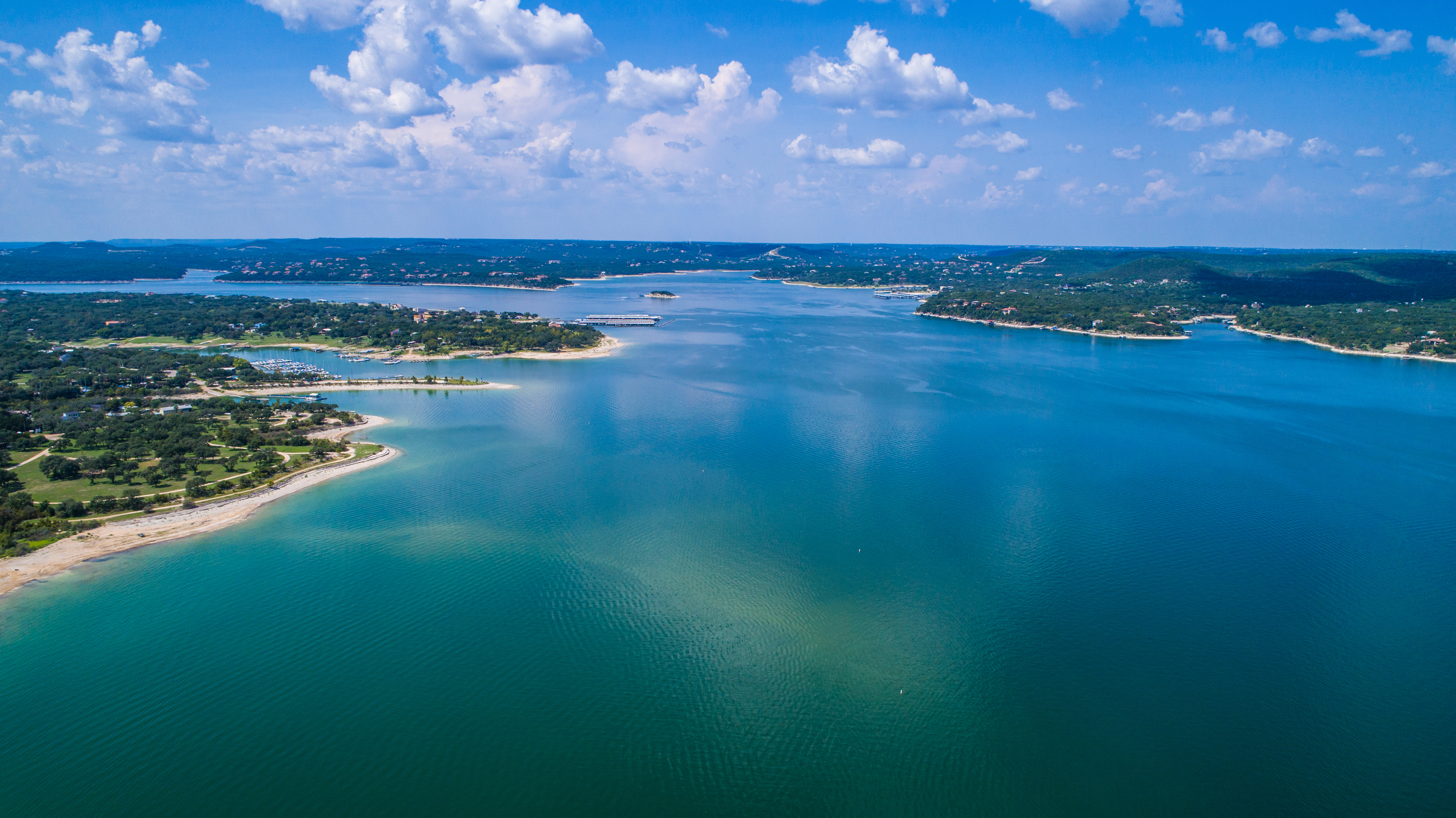 Aerial view above Lake Travis and Lakeway Homes along Water's Edge