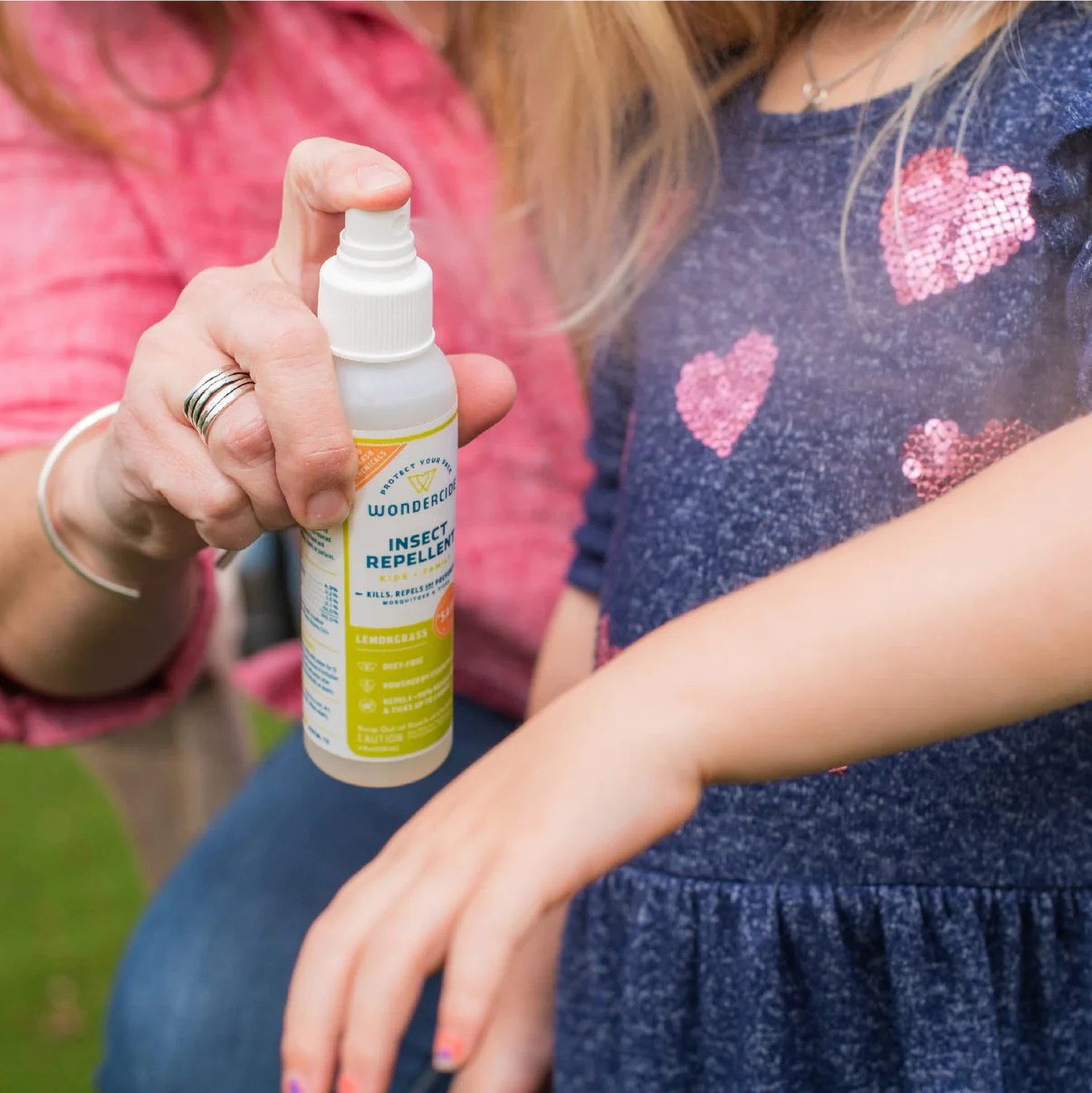 Person spraying Wondercide Bug Spray onto child