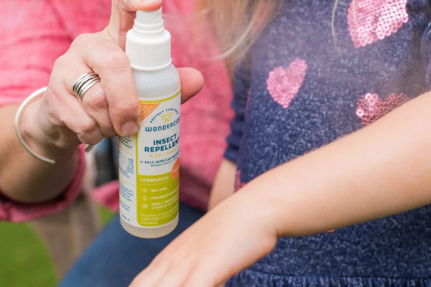 Person spraying Wondercide Bug Spray onto child