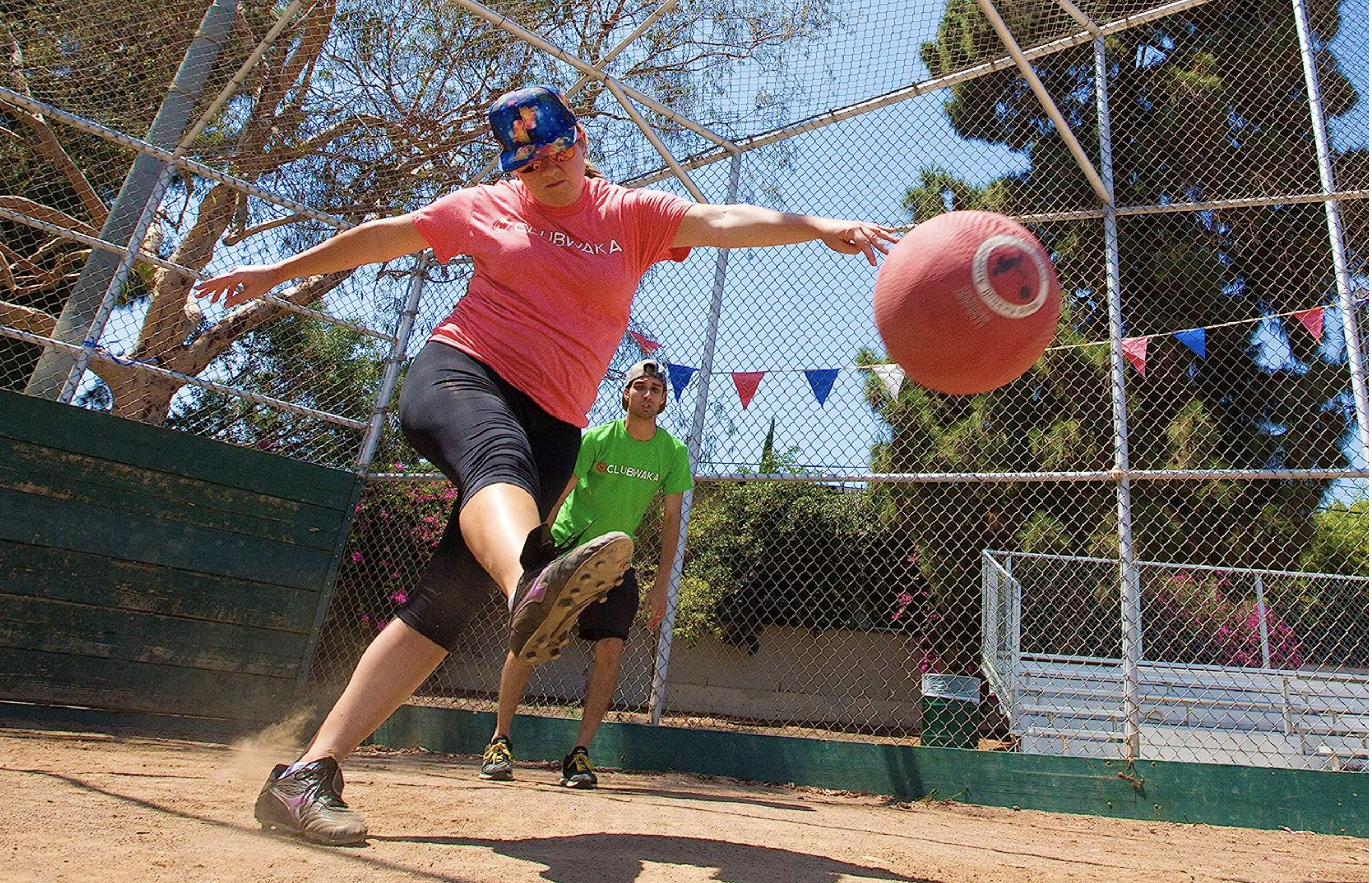 Player kicks the ball at home plate. 