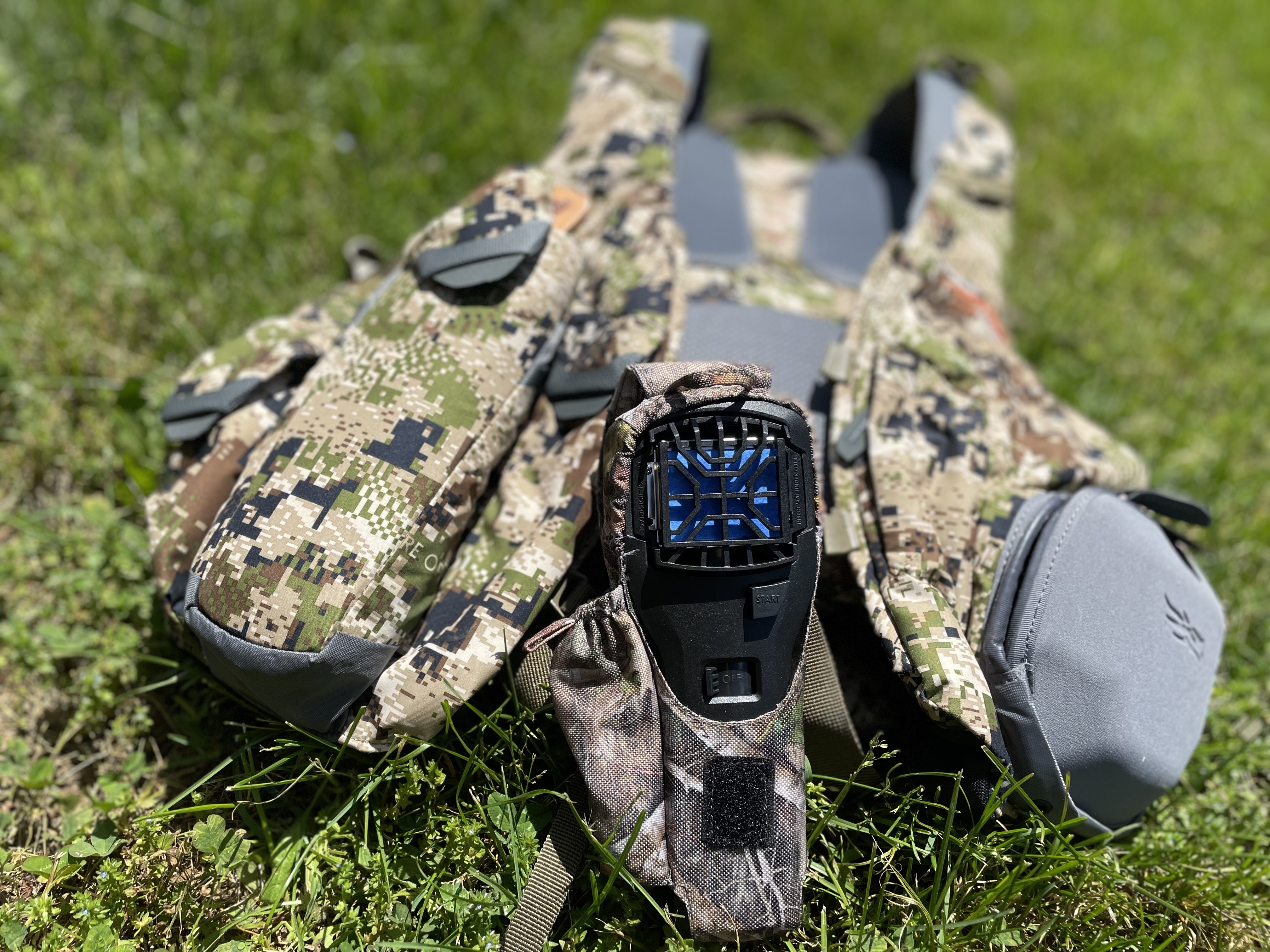 Camouflage Thermacell mosquito repellent resting on grass