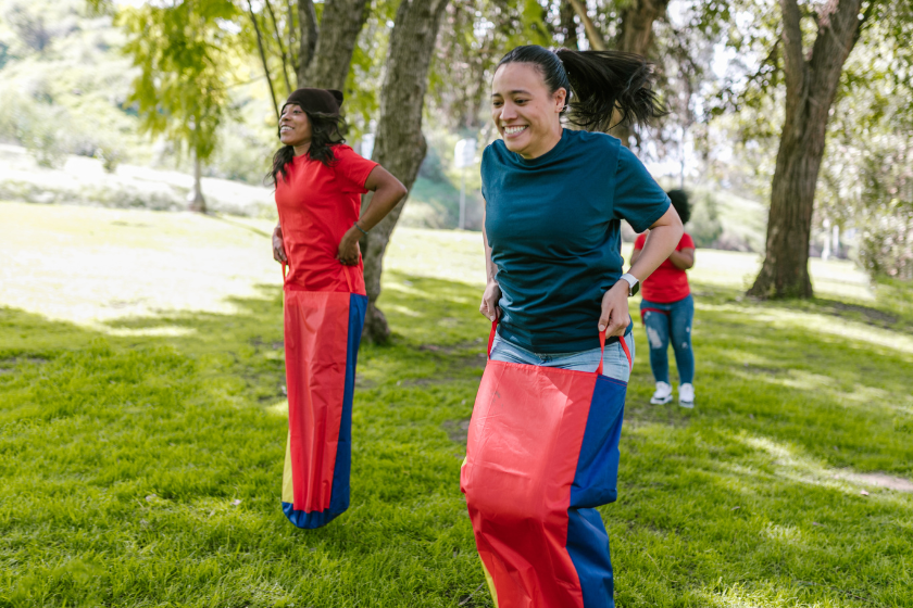 People participating in a potato sack race.