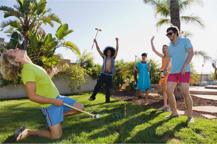 Friends playing croquet