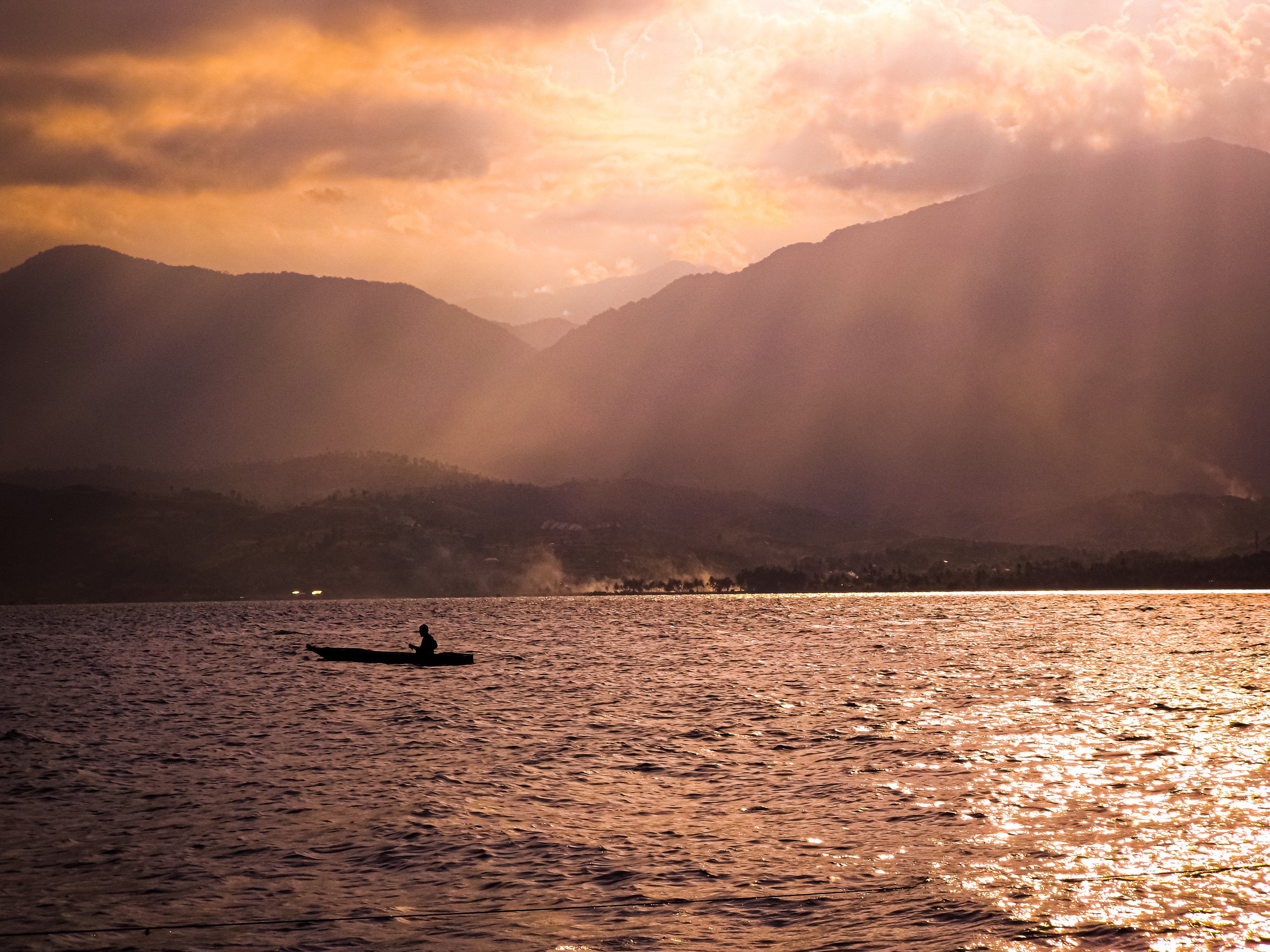 Fishermen catch fish in Singkarak lake on a sunny afternoon, West Sumatra, Indonesia.
