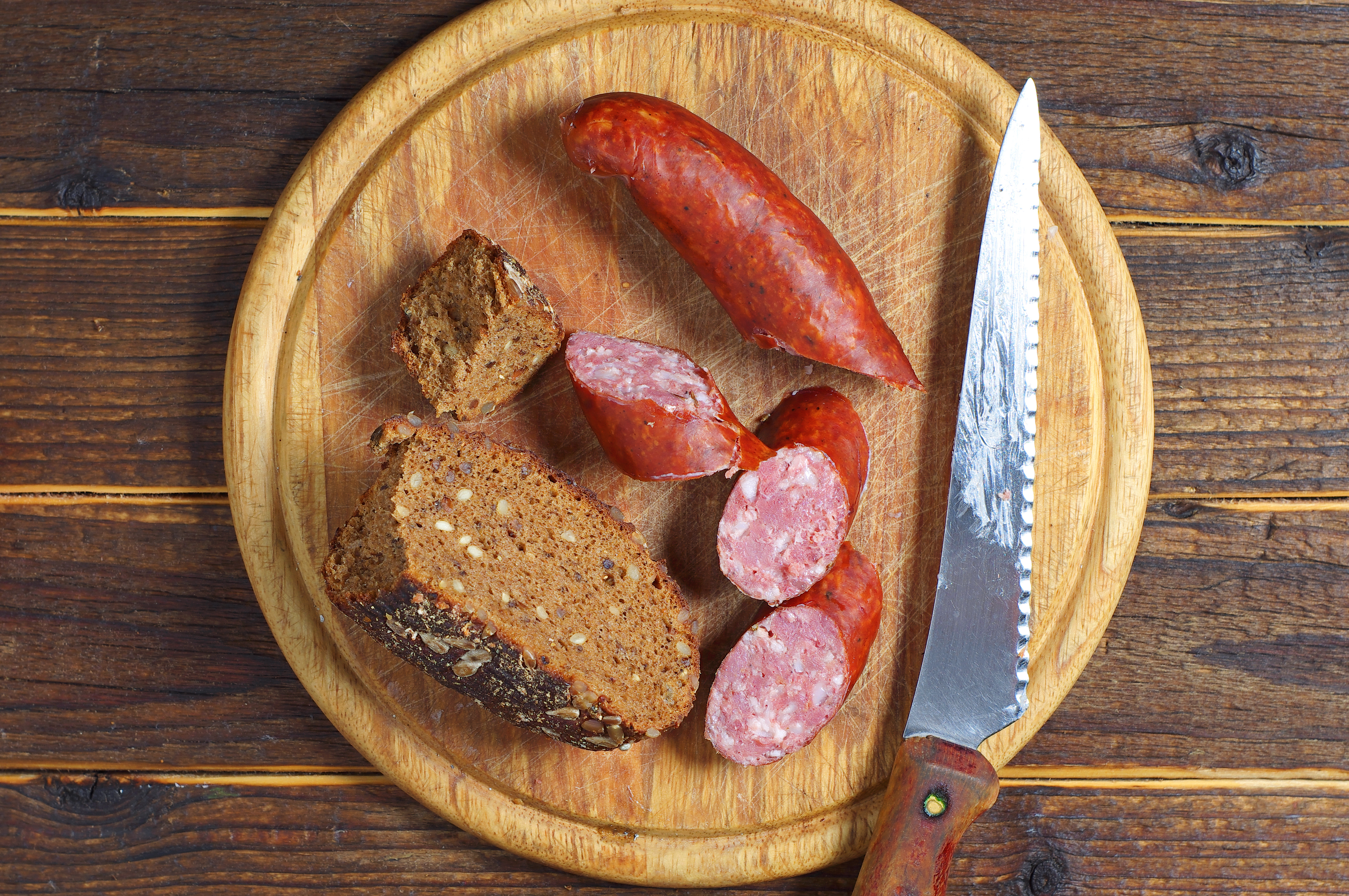 Homemade smoked sausage on a kitchen board, top view