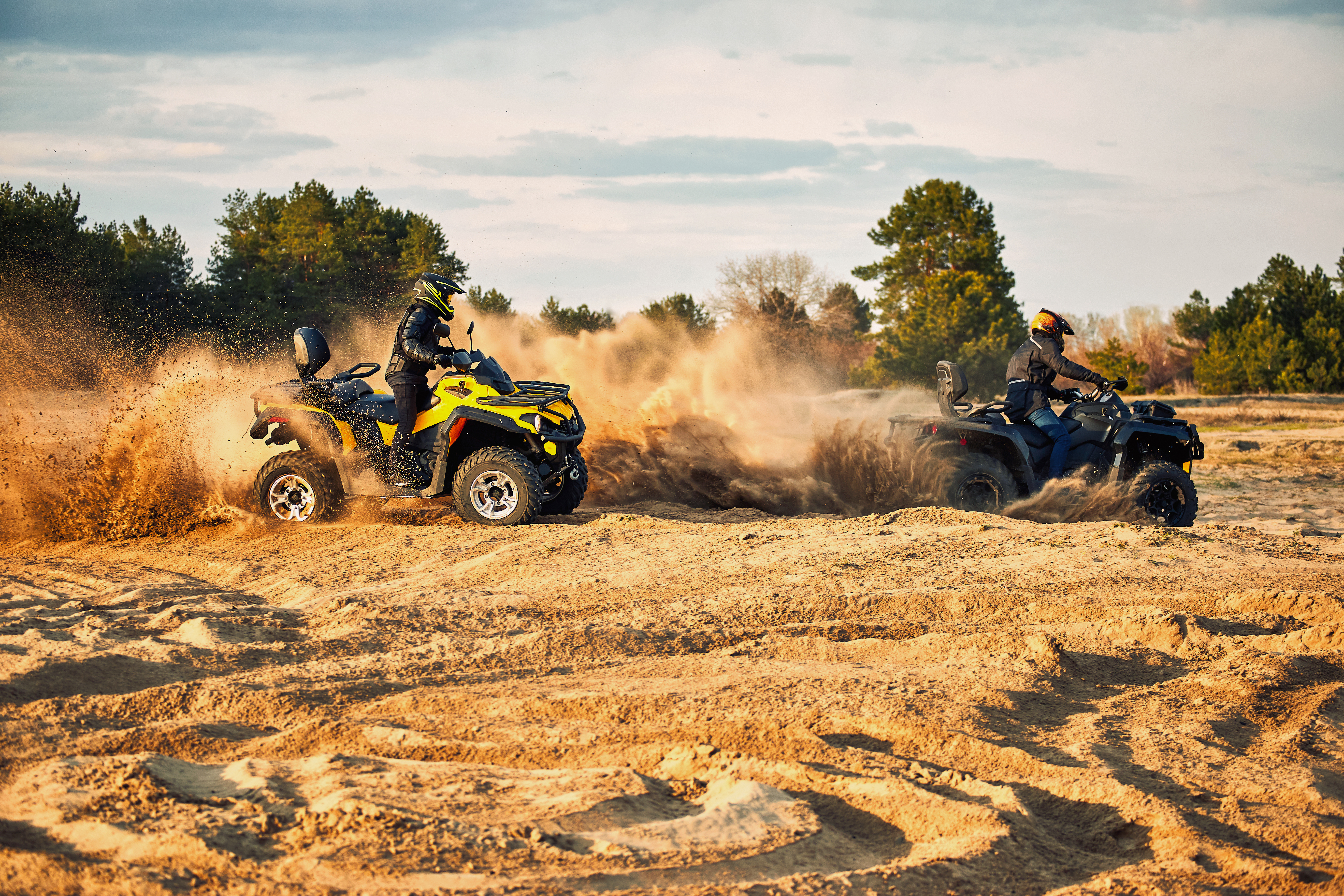 Racing powerful quad bike on the difficult sand in the summer.