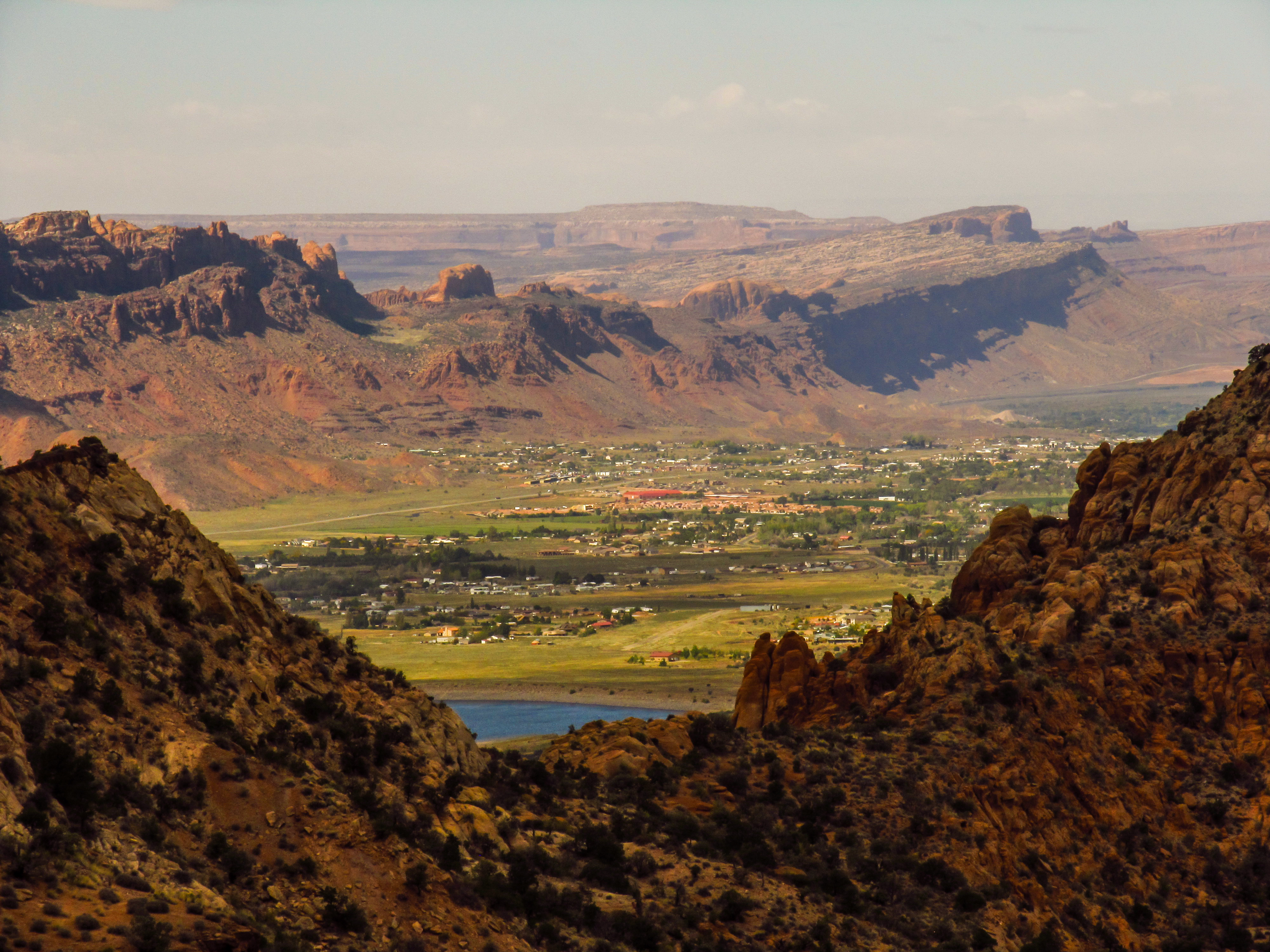 View over the town of Moab in Utah, USA, situated between sandstone ridges, as seen from the La Sal Mountains