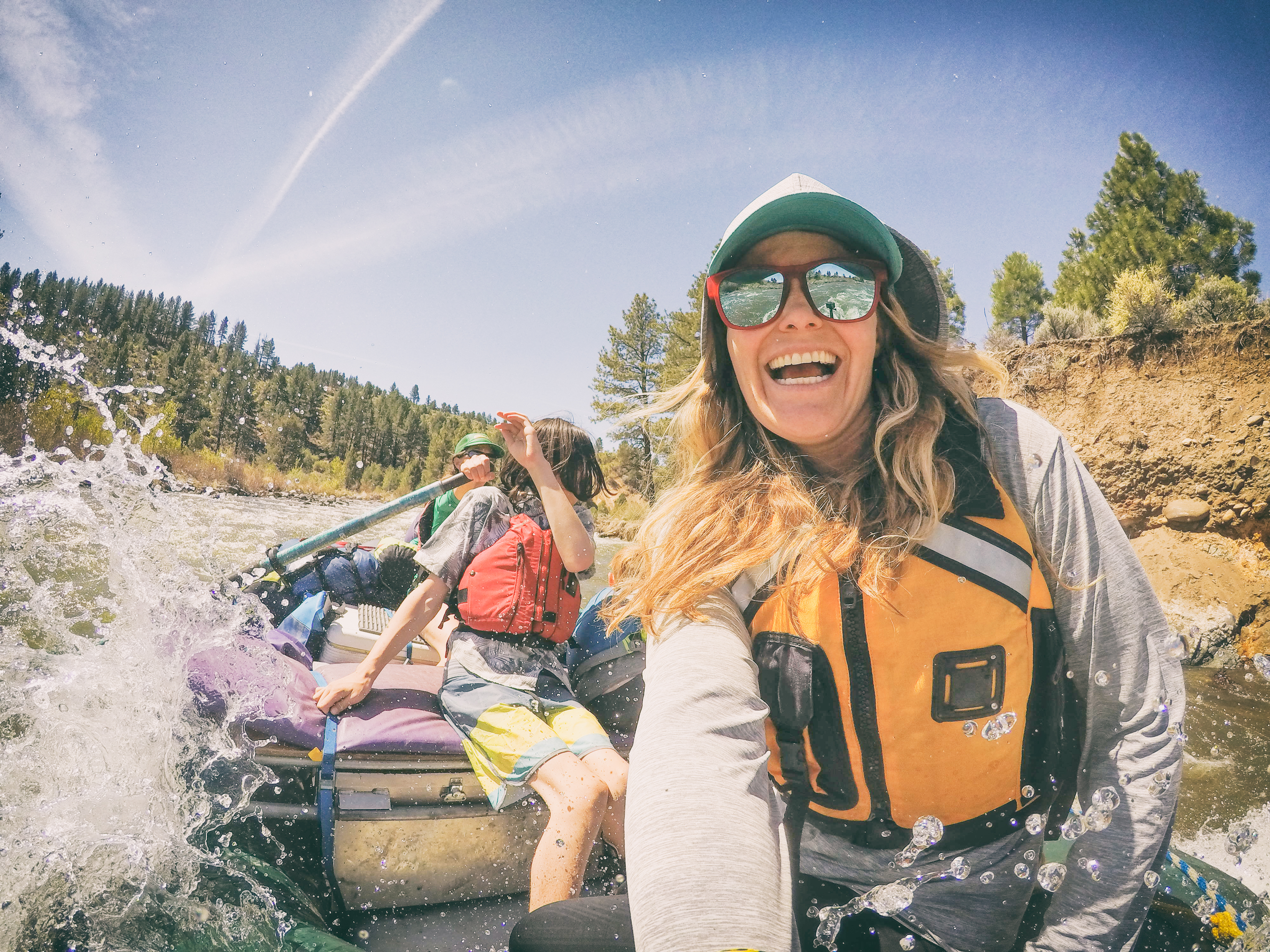 A couple take their children on a white water rafting camping trip in California.