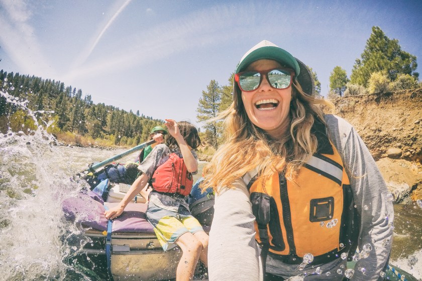 A couple take their children on a white water rafting camping trip in California.