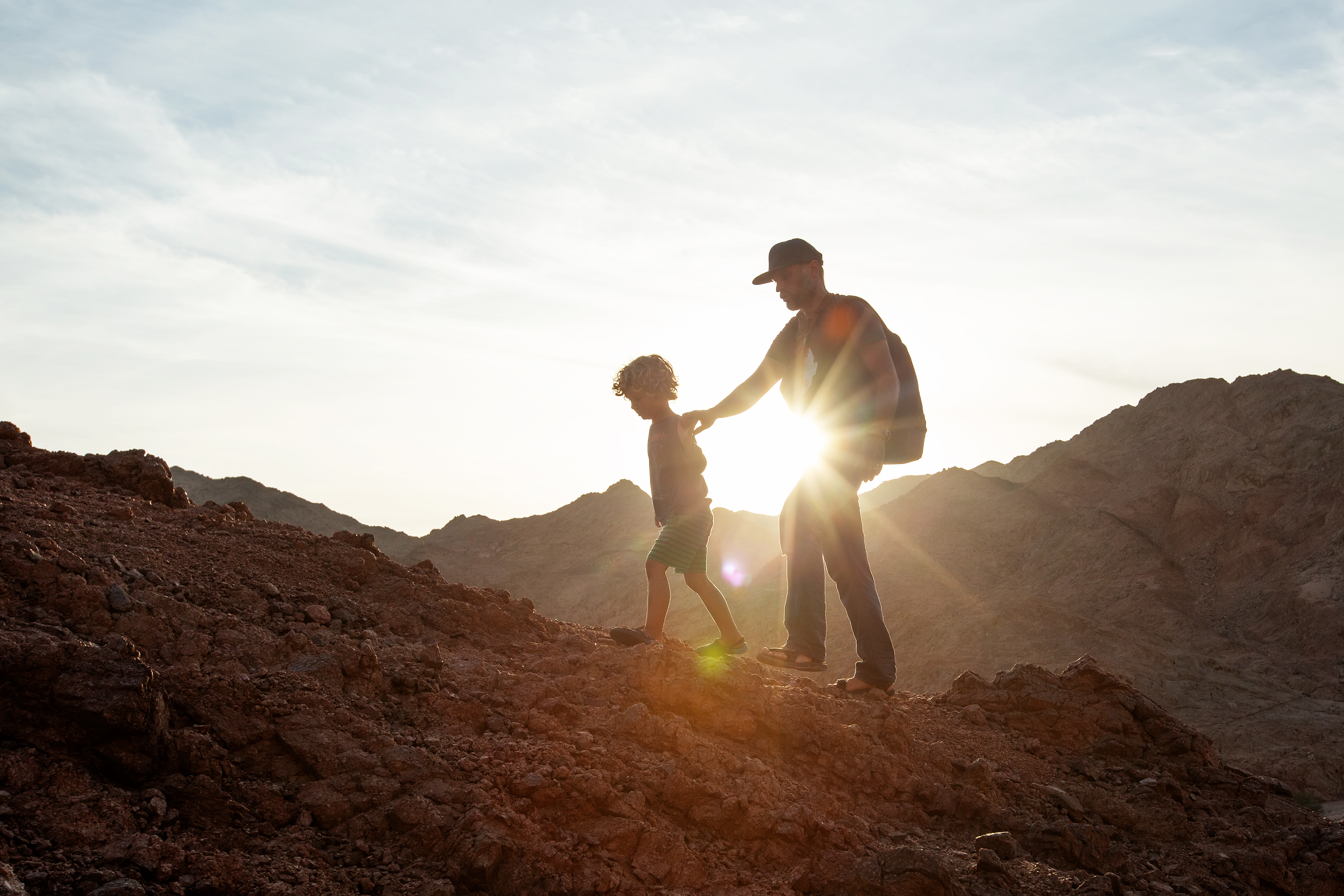 Dad with son in the mountains in the desert