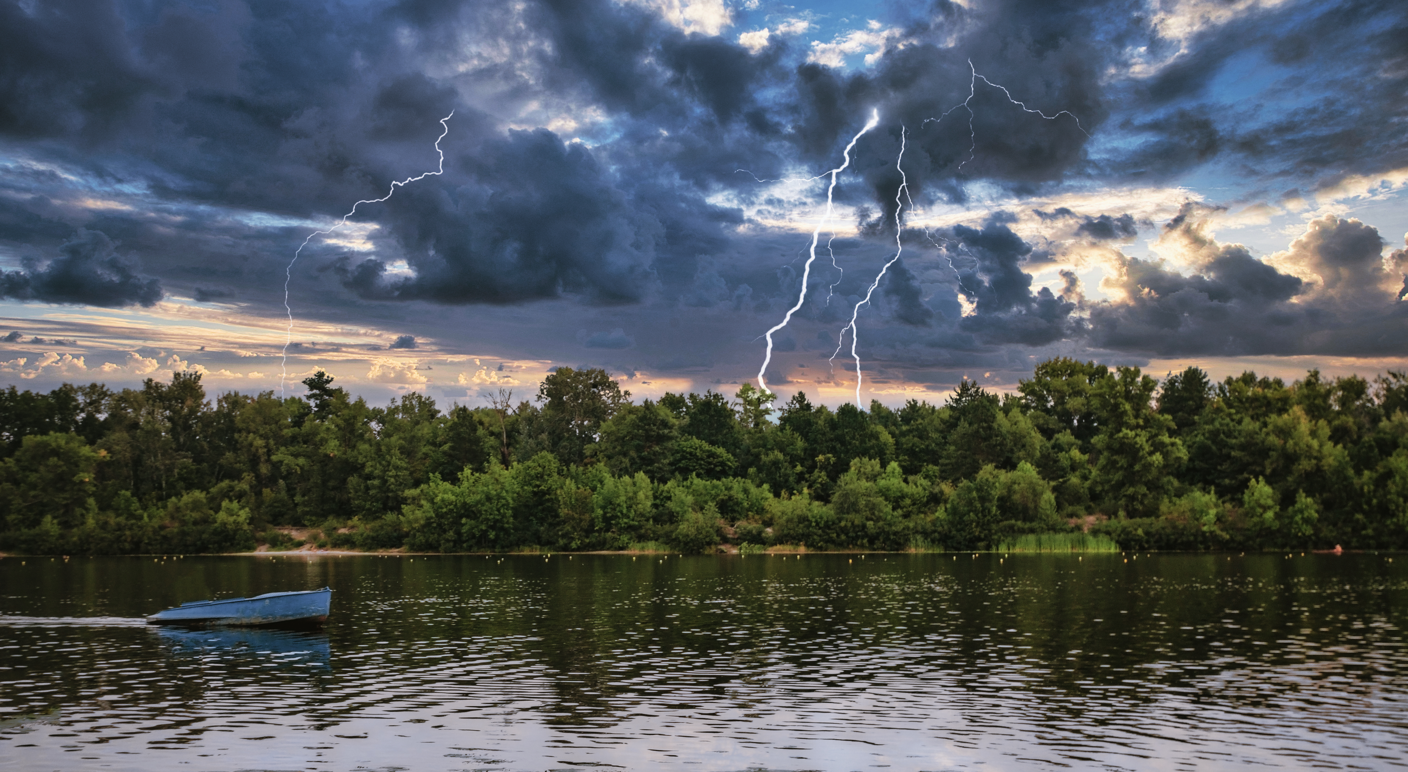 A forest lake under thunderclouds with lightning.
