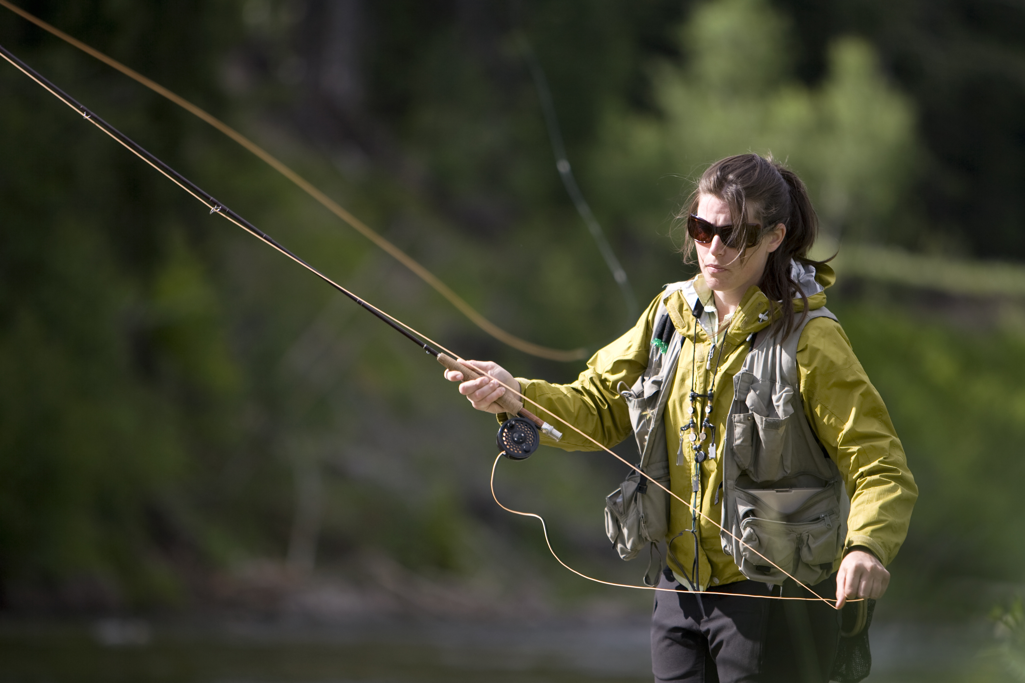 Woman fly fishing in British Columbia. 