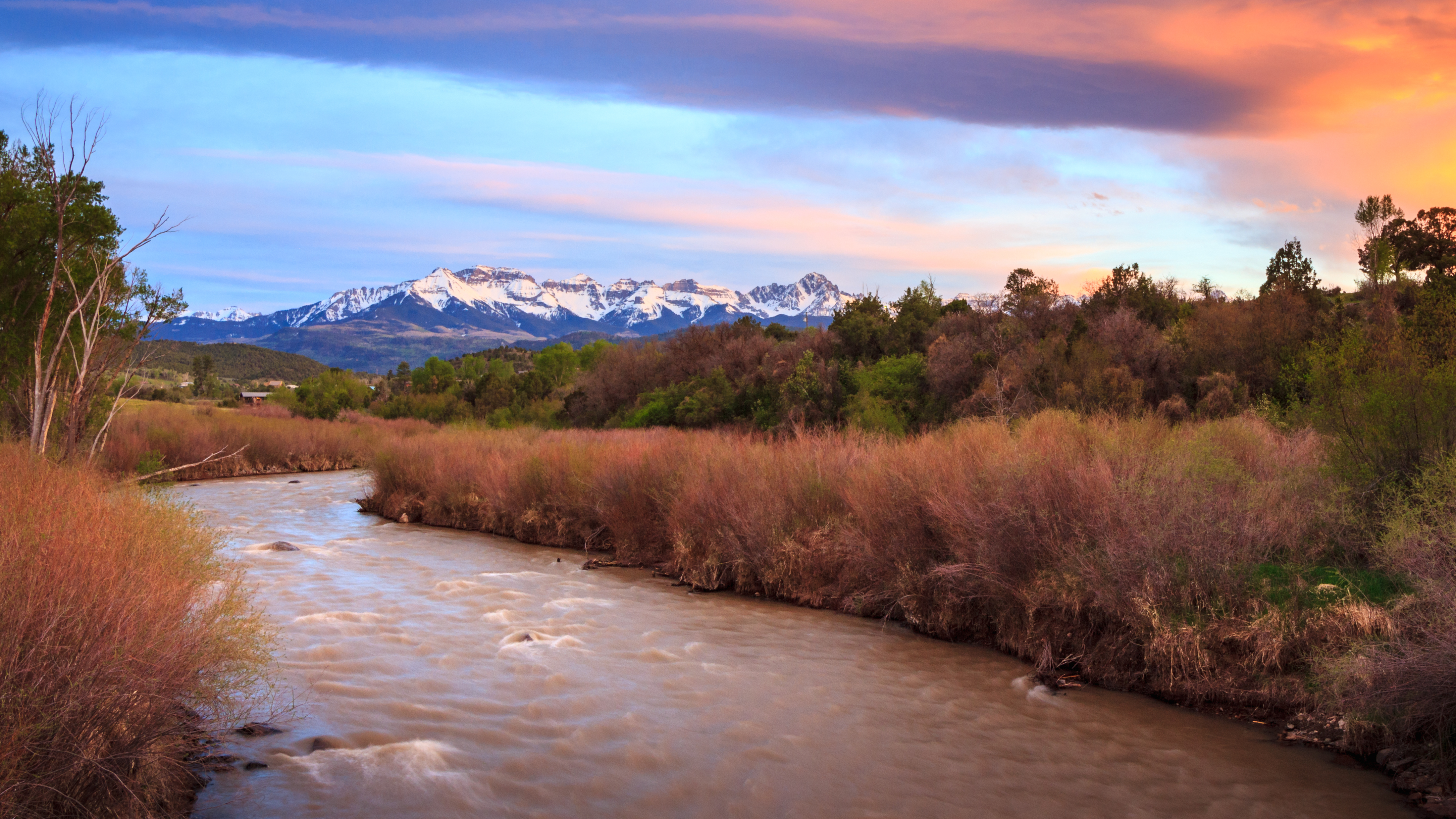 Sunset at Ridgway State Park, Colorado with the snow capped San Juan Mountains in the background. 
