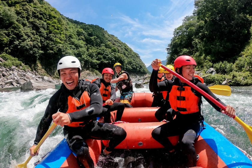 Personal point of view of a group of men and women while white water river rafting