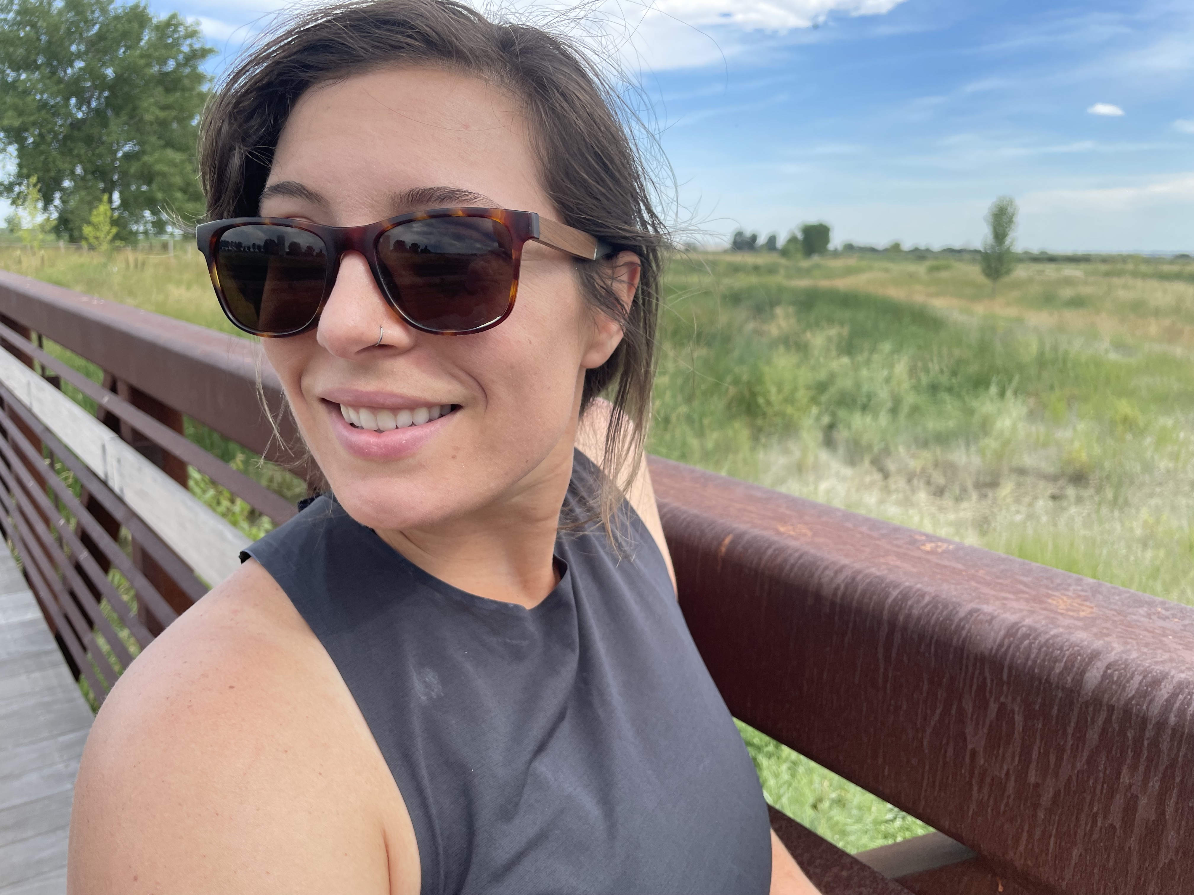 Author wearing CAMP sunglasses in front of an outdoor trail
