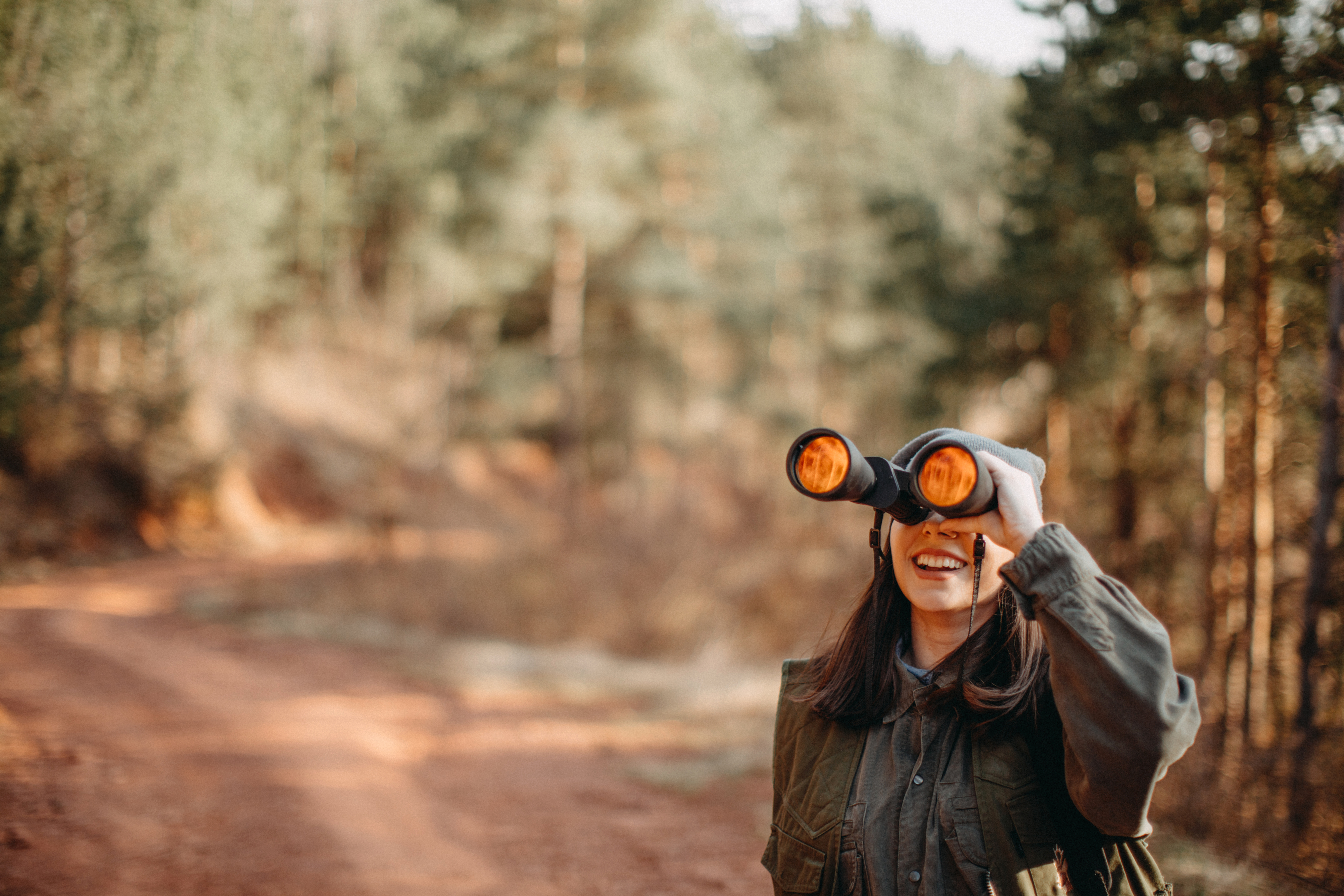 Woman looking through binoculars