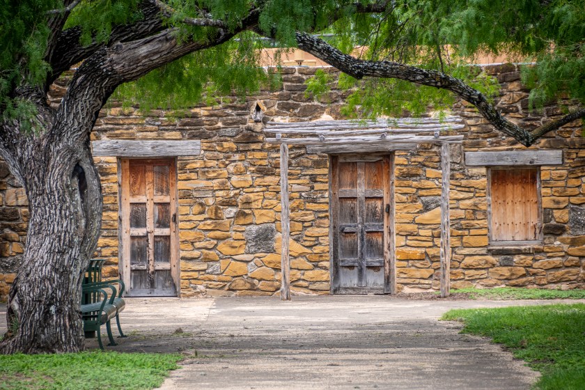 An historic building in San Antonio Missions National Historical Park beneath a large tree. (Photo by: Edwin Remsberg/VW Pics/Universal Images Group via Getty Images)