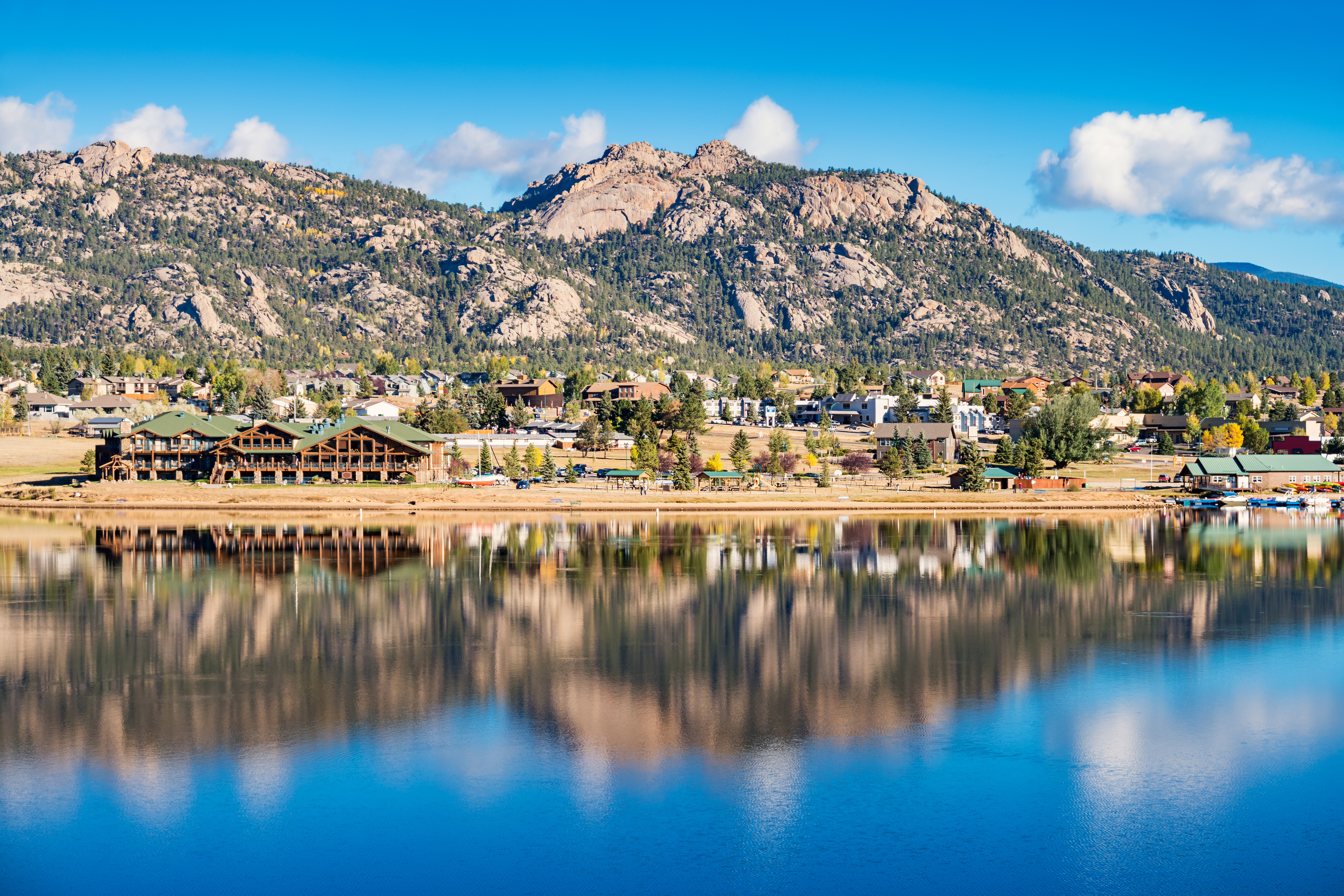 Stock photograph of the town of Estes Park reflecting in Lake Estes Colorado USA on a sunny day.