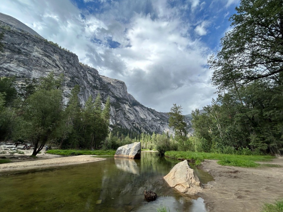 A body of water, trees, and mountains found on the Mirror Valley Trail
