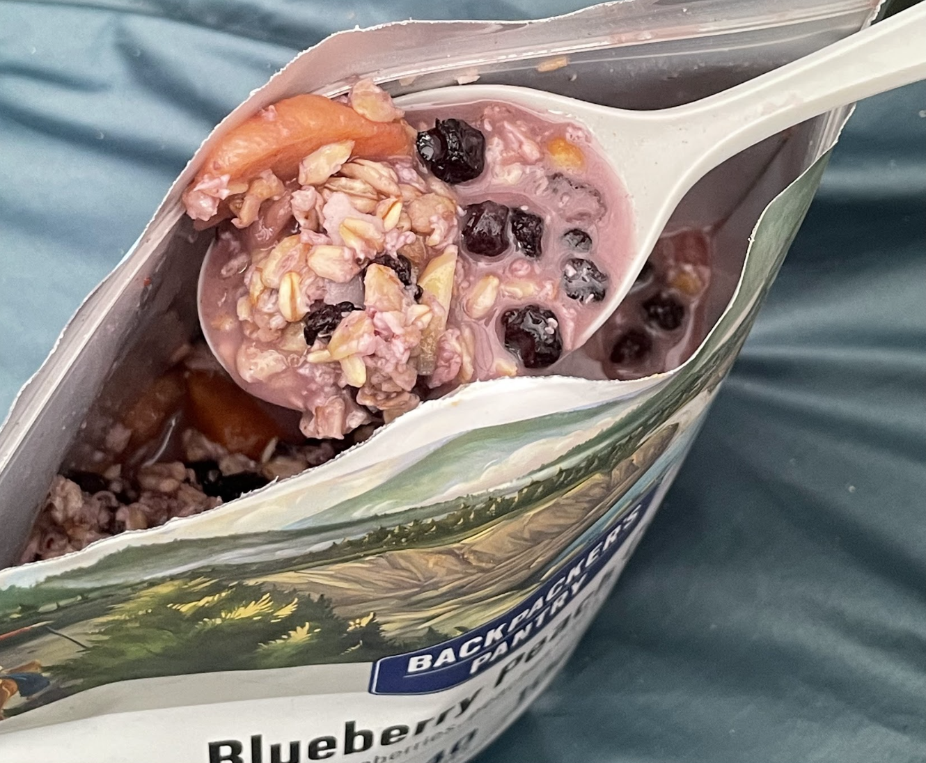 An open pouch of Backpacker's Pantry Blueberry Peach Crisp