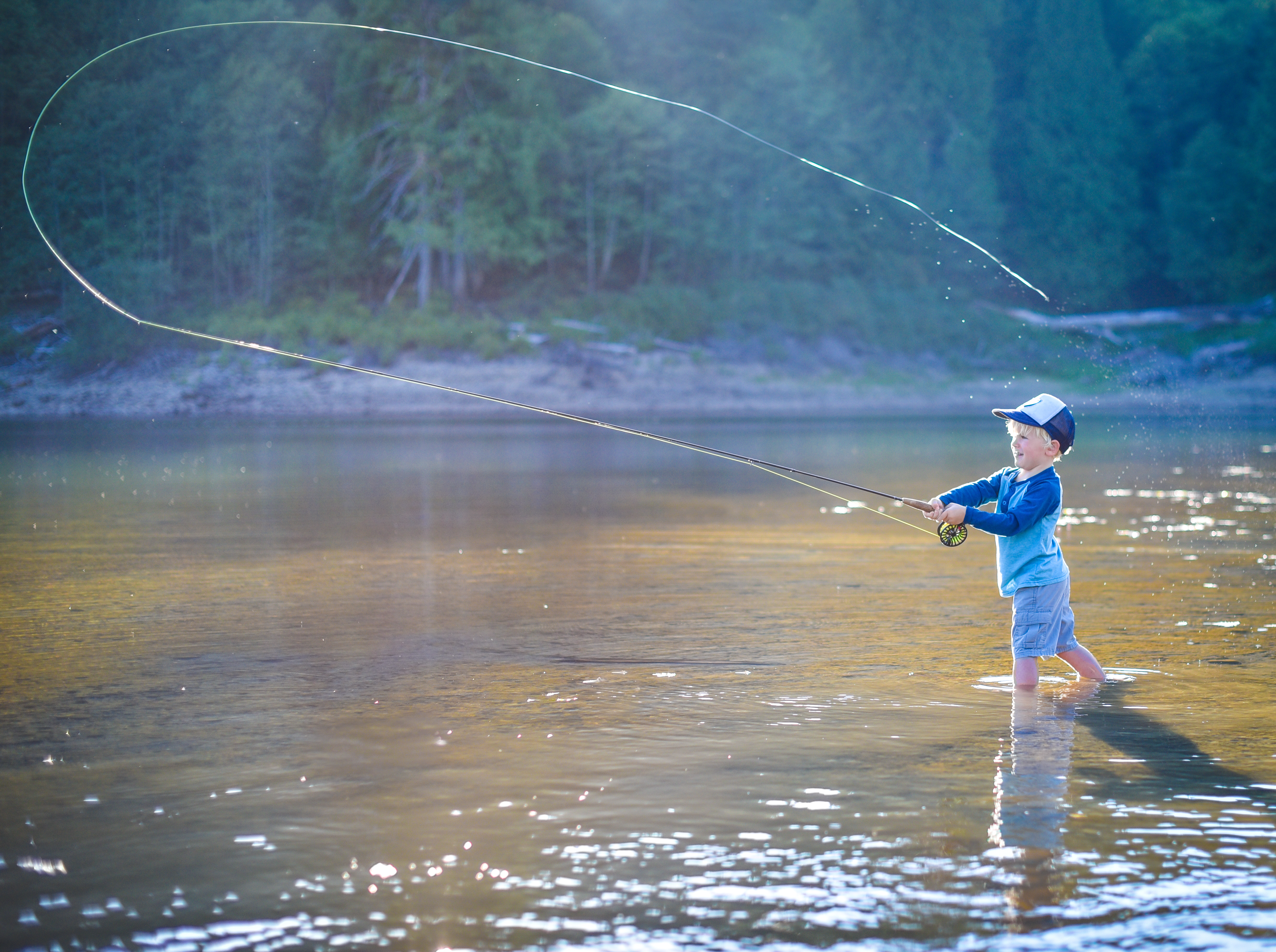 Boy fly fishing