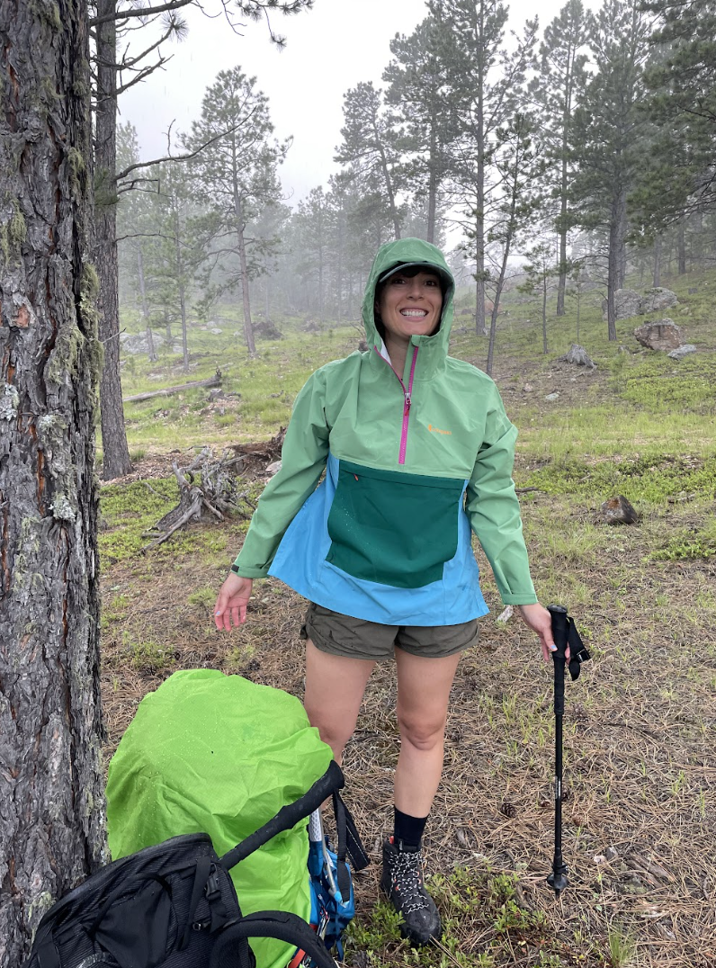 Photo of the author wearing a two-tone green and blue rainjacket