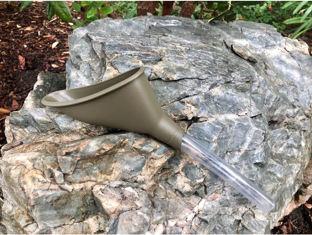 A forest green pee funnel resting on a rock 