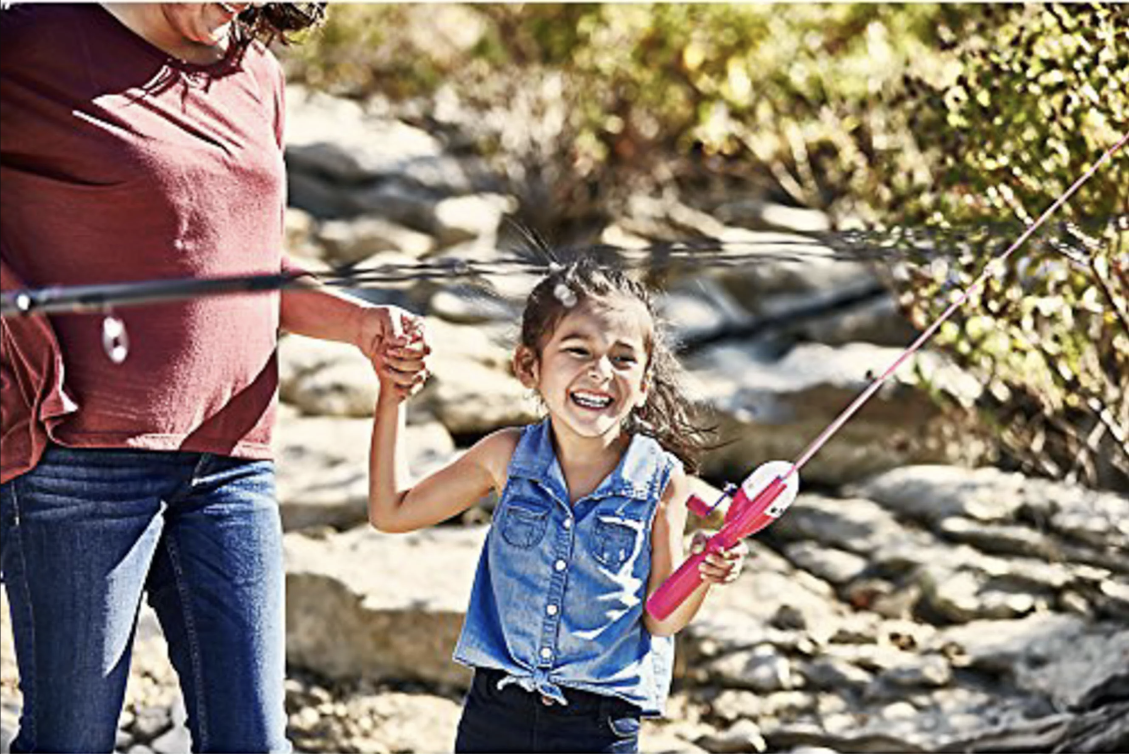 A child holding a Barbie fishing rod