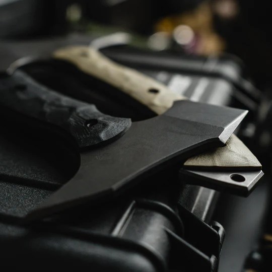 A black Toor Knives axe