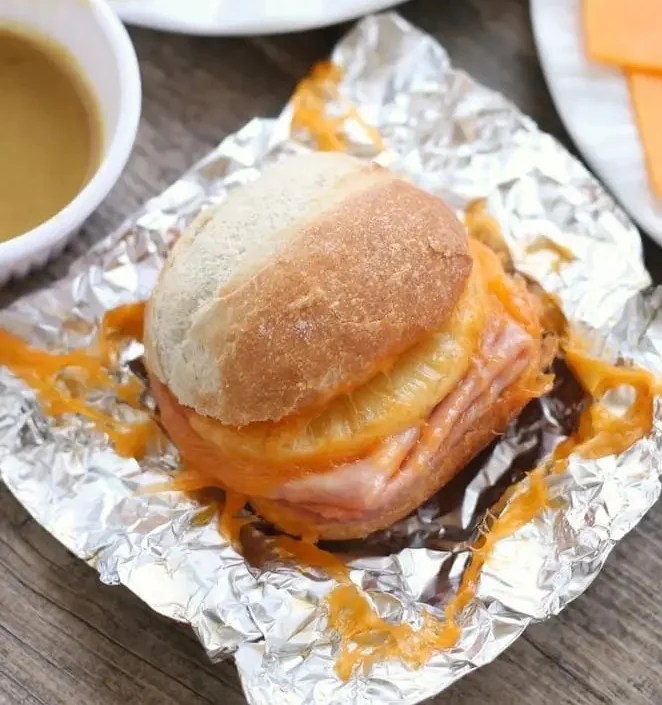 A ham and pineapple sandwich in a piece of tin foil 
