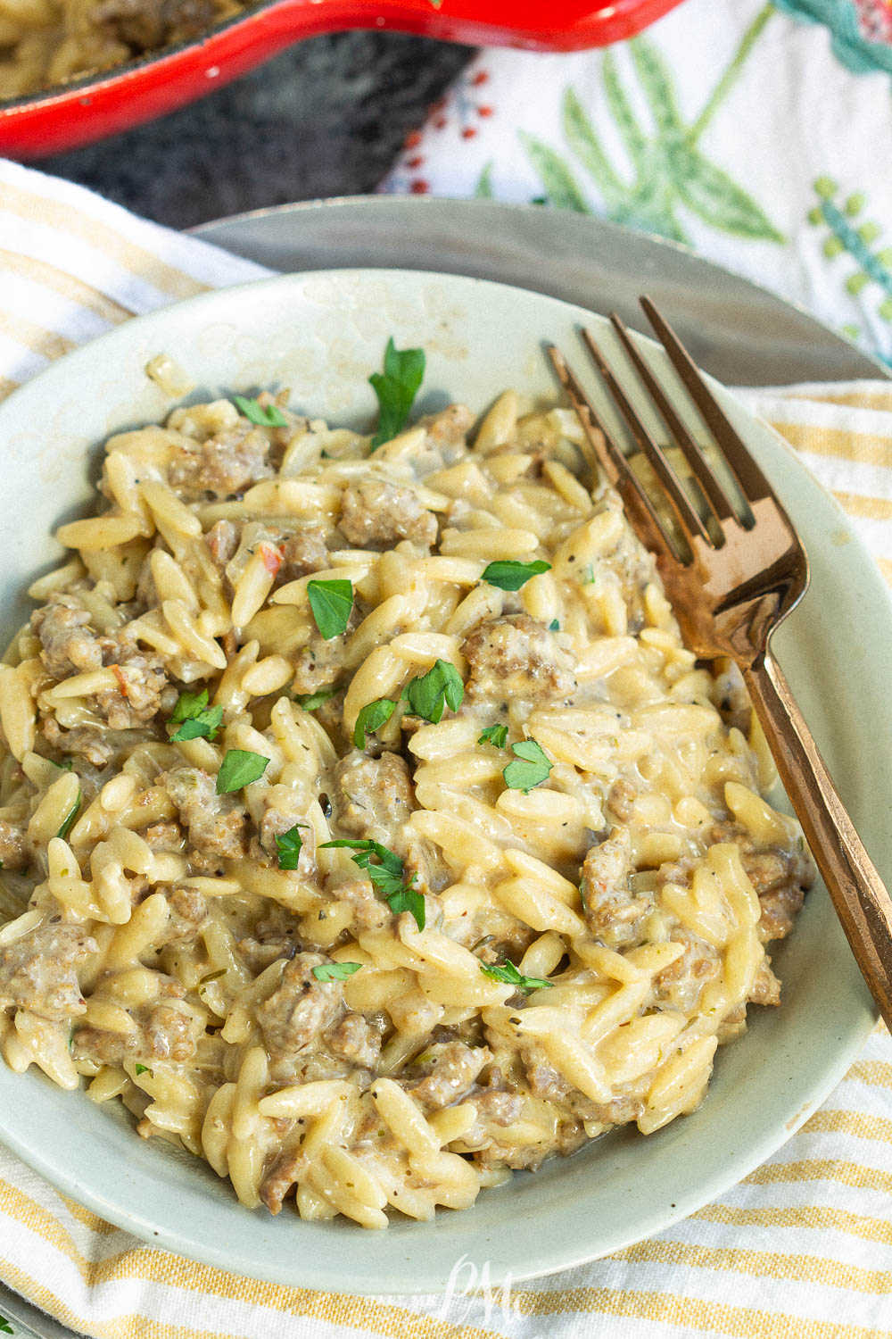 Italian sausage orzo in a mint colored bowl 