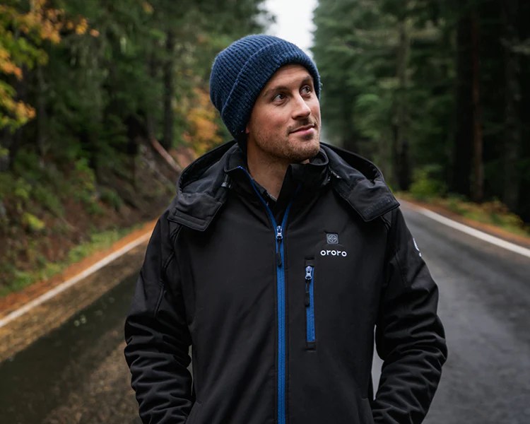 Person walking on a road while wearing an Ororo jacket