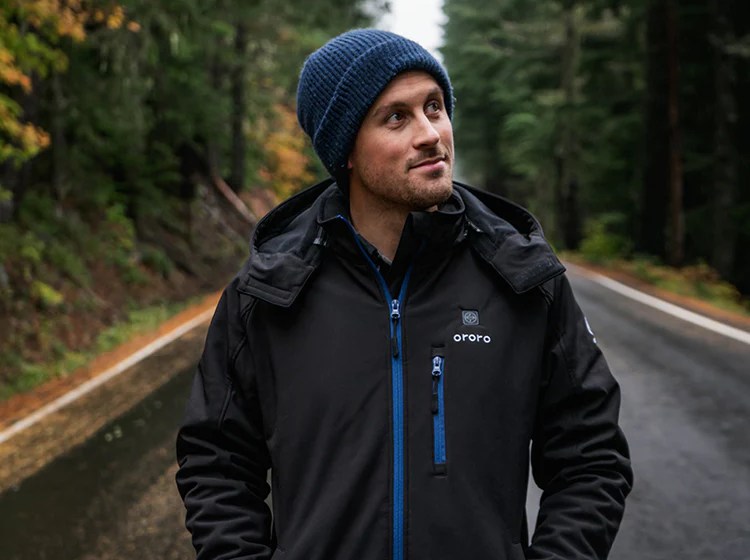 Person walking on a road while wearing an Ororo jacket
