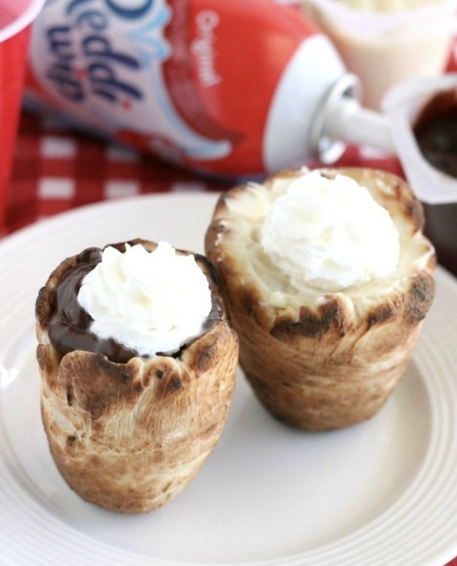 dough cups filled with chocolate and whipped cream