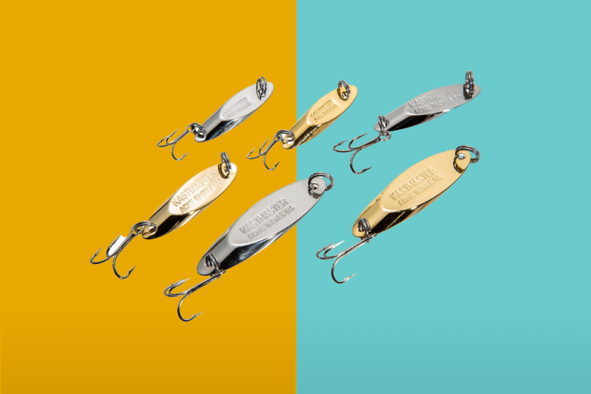 A series of silver and gold fishing spoons on a blue and yellow background