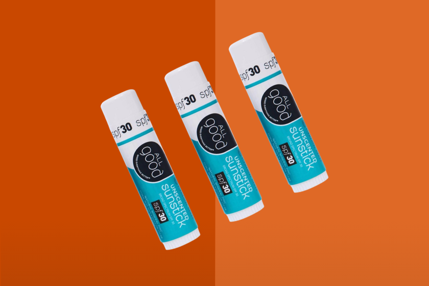 Three All Good Sunscreen sticks placed on an orange background