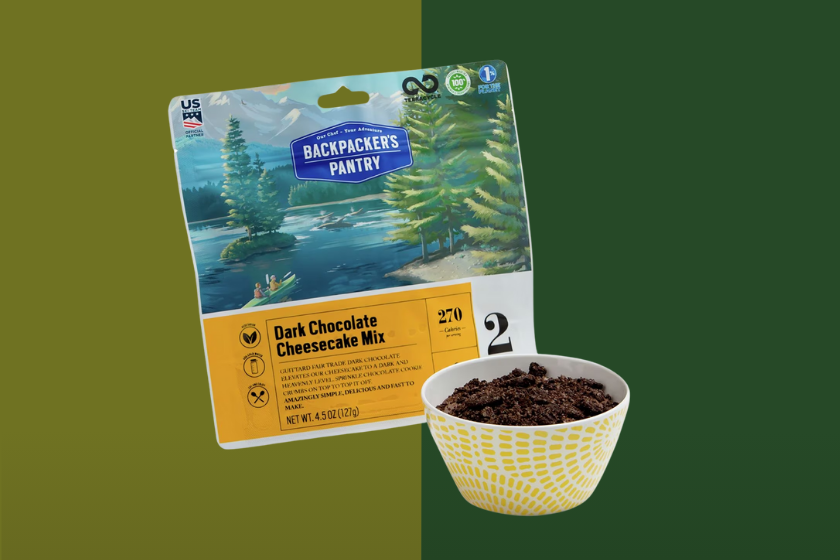 A package of Backpacker's Pantry Dark Chocolate Cheesecake on a green background