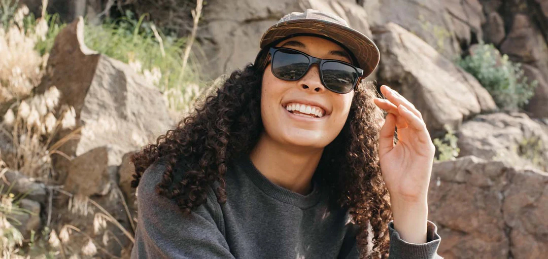 Person wearing Camp Trail sunglasses in front of a series of rocks 