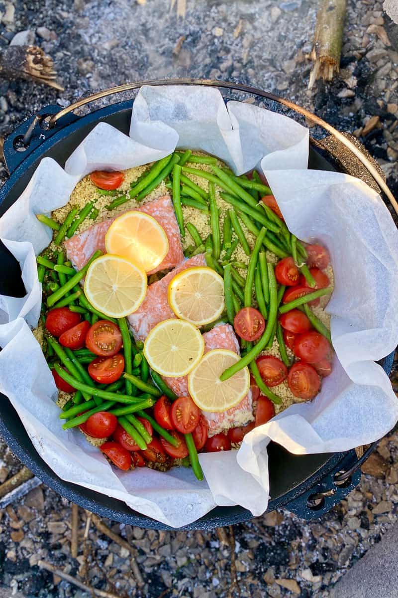 Salmon with green beans and tomatoes in a cast iron skillet